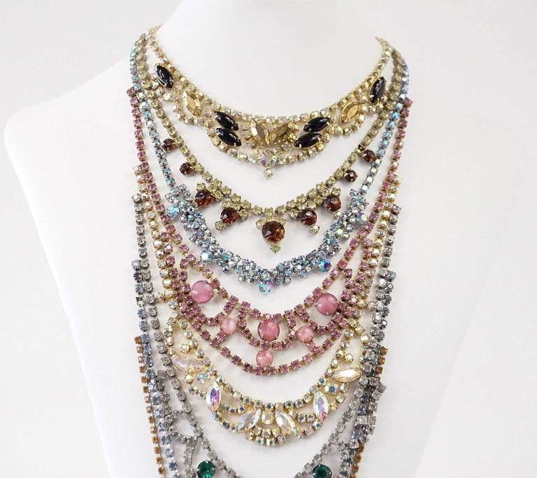 Guaranteed authentic beautifully handcrafted Erickson Beamon 8 tiered long necklace.
Faceted diamantes in various sizes and colours with soft pink cabochons.
Large faceted Amber drop stone at end.
This smashing medly is created from vintage
