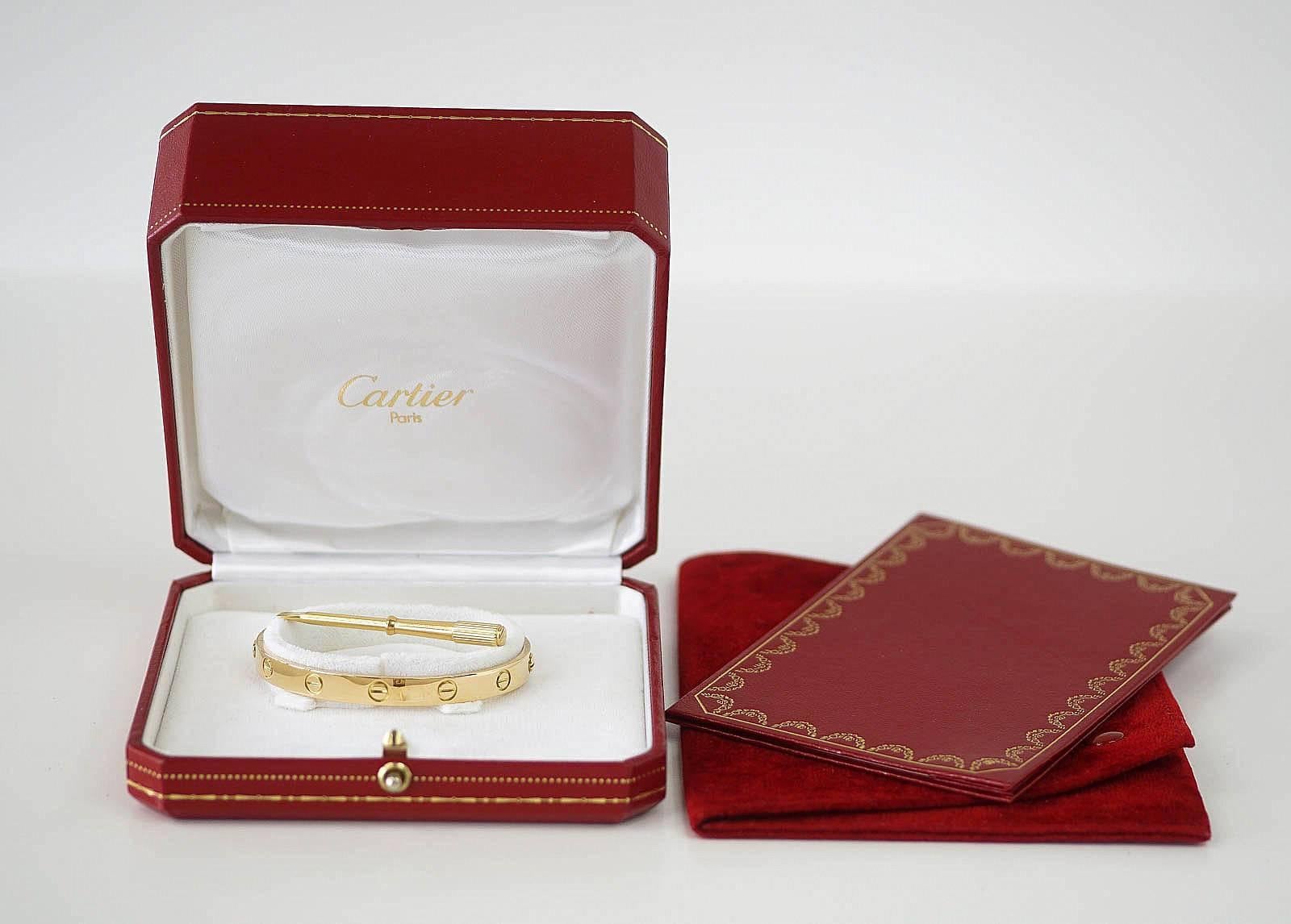 The iconic symbol of love!  
18K yellow gold size 17.
Comes with signature Cartier box, screw driver, papers and pouch. 
Final Sale

SIZE: 
17

CONDITION:
MINT