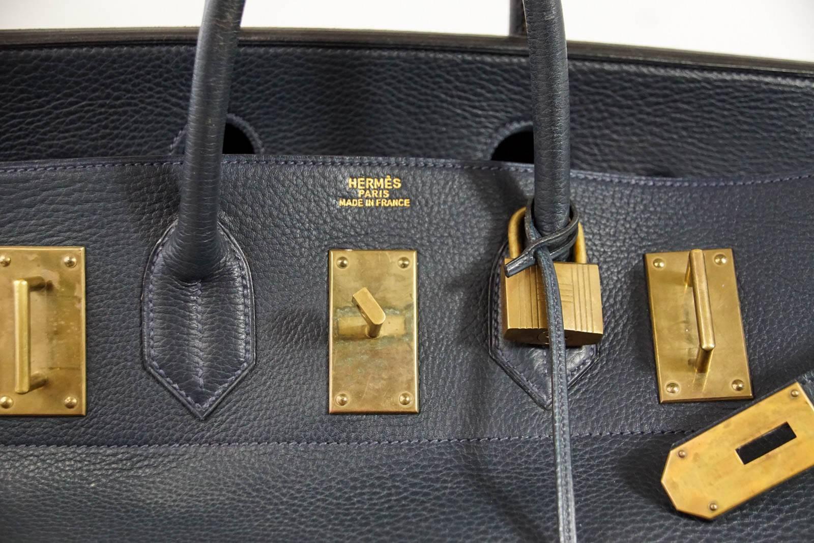 Guaranteed authentic uber rare Vintage 55 Hermes Hac in rich Navy coveted Fjord leather.  
A striking combination with aged brass hardware.   
This beautiful bag is a true Hermes collectors treasure. 
Natural wear marks
Comes with lock, keys and