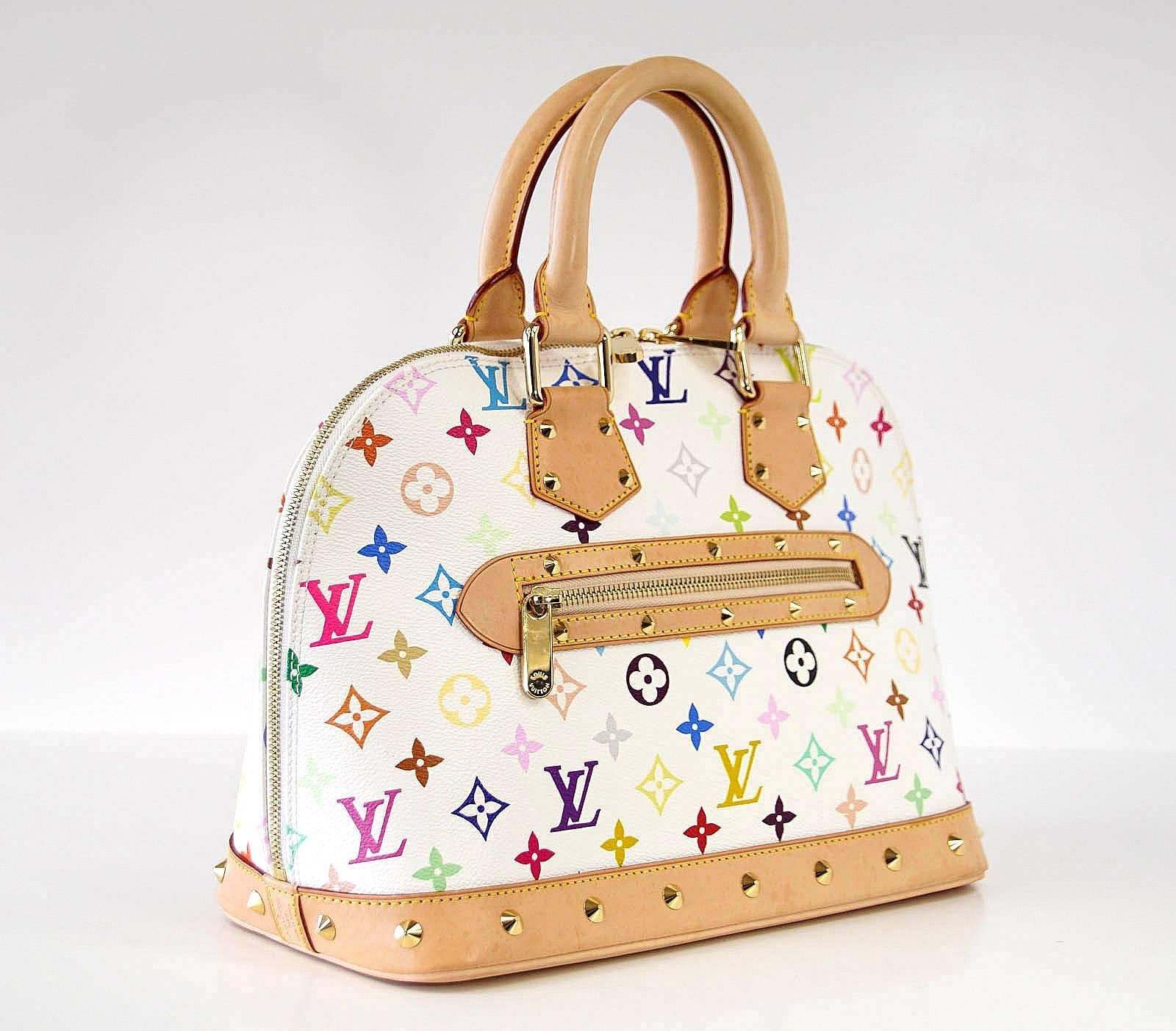 Guaranteed authentic iconic White Murakami Louis Vuitton Alma bag.
Signature hardware.
Double zipper with logo embossed pulls.
Rounded leather handles.
Exterior zip pocket.
Interior  has cellphone pocket and 1 slot pocket.
Signature red suede