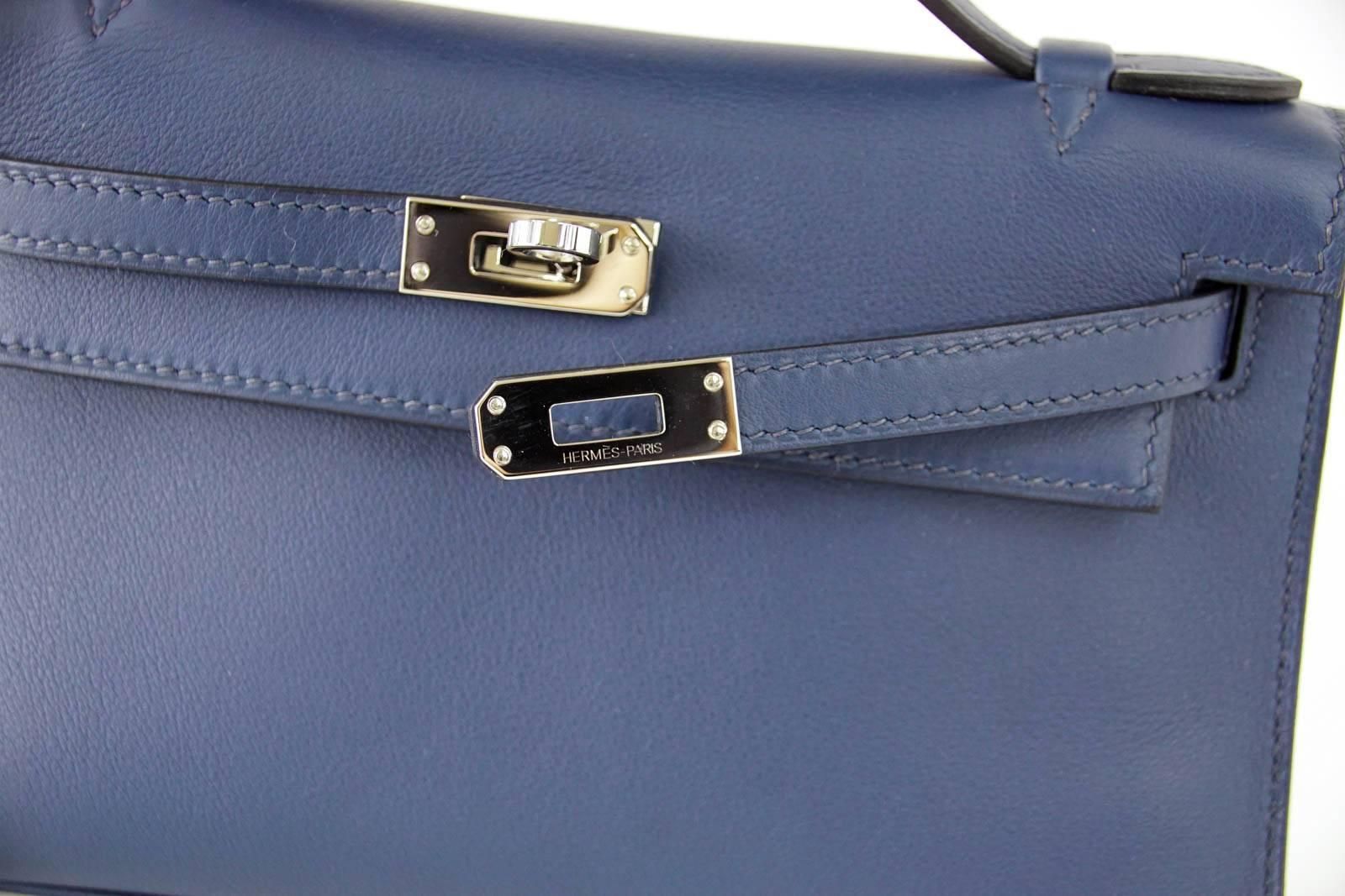 Guaranteed authentic HERMES beautiful Bleu de Prusse in Swift Leather.
So chic with Palladium hardware.
This treasure is easily carried day or night, casual to dressy.  
Signature stamp on interior.
Small interior compartment.
Comes with sleeper and