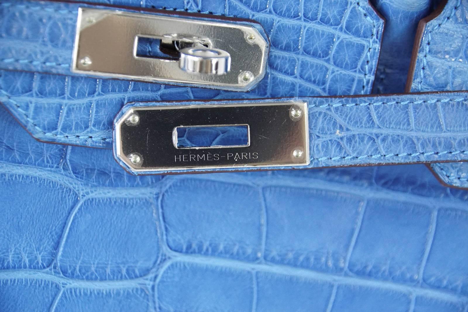 Guaranteed authentic Hermes Birkin 35 exquisite blue Mykonos in Alligator.
Cool with Palladium Hardware.
Plastic on hardware.
Very light natural wear marks on corners. 
Handles and body are mint. 
Interior has a light mark at base are on the side.