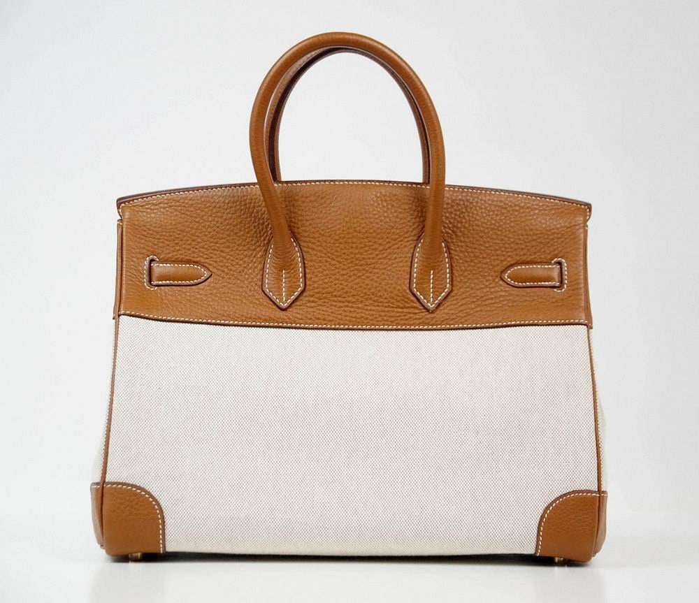 Guaranteed authentic Hermes Birkin classic combination in Toile and Gold Clemence leather.
Gold hardware.  
Clean corners, handles and body.  Lock has light wear.
One front corner has a small scuff.  
Plastic on hardware.
Comes with sleepers, lock,