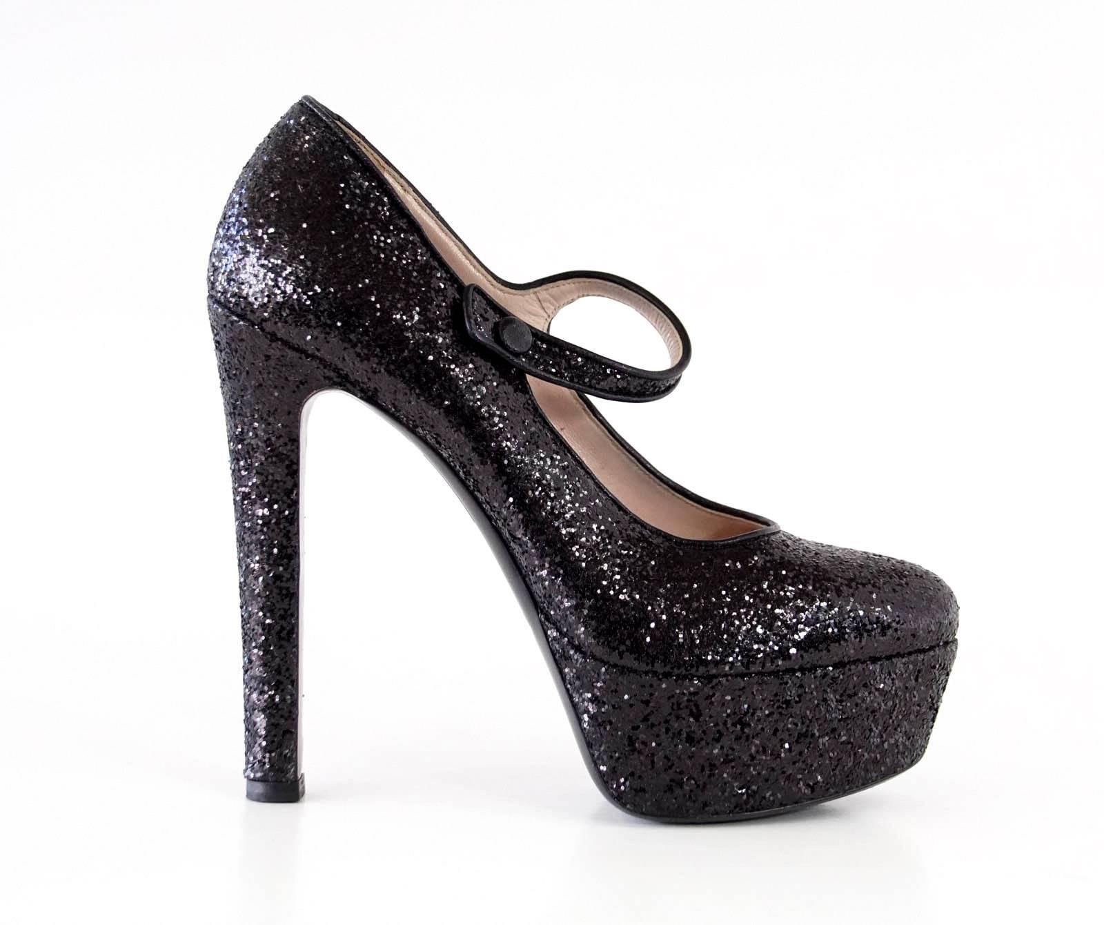 Guaranteed authentic MIU MIU jet black glitter bold platform Mary Jane style.
Fabulous statement shoe from dressy to jeans!
Rounded toe
Comes with sleeper.
LIKE NEW
final sale

SIZE 38
USA SIZE 8

SHOE MEASURES:
HEEL  5.5" 
PLATFORM