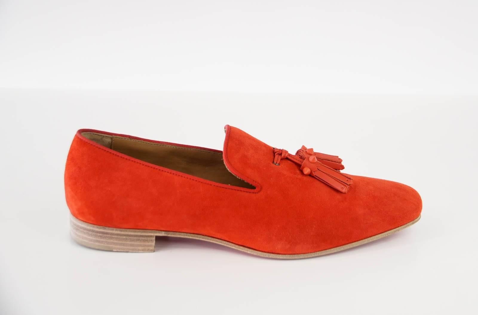 Guaranteed authentic Christian Louboutin very beautiful red suede loafer. 
Men's soft toned red loafer with leather tassles.
Tassels are accentuated with signature red spikes.
Comes with box and sleeper.
final sale

SIZE 42
USA SIZE