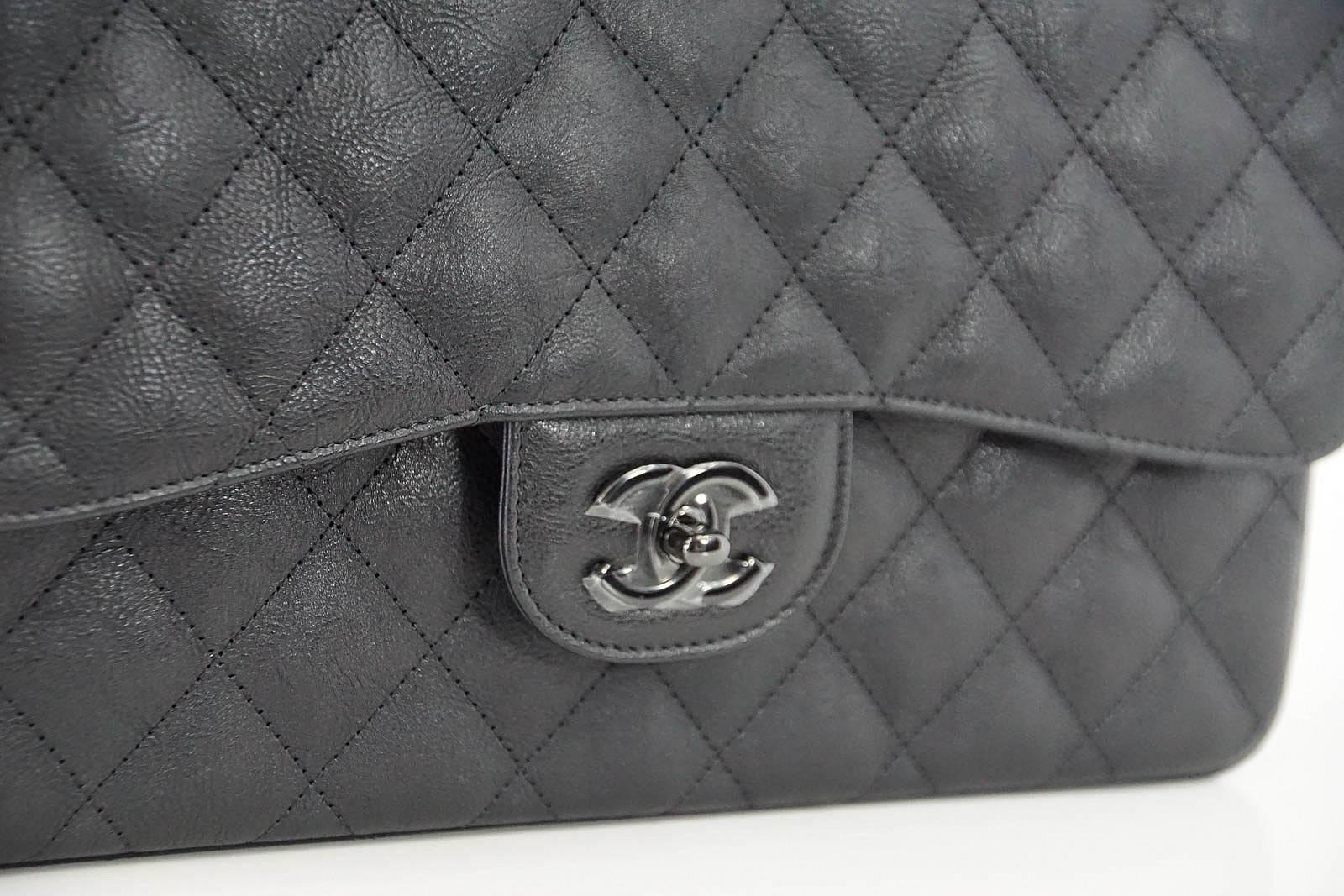 Guaranteed authentic CHANEL coveted So Black in rare quilted crumpled calfskin.
The matte finish of the leather with the shiny black hardware is timeless.
Signature chain and CC turnkey closure. 
Signature CHANEL stamp inside the bag. 
Serial number