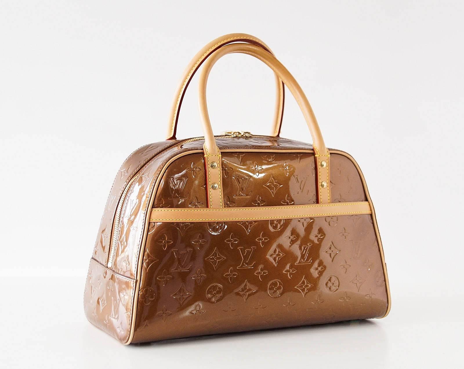 Guaranteed authentic LOUIS VUITTON bronze Tompkins Square Satchel Monogram vernis bag. 
Classic beauty.
Top zip with logo embossed pull.
Exterior slot pocket in front.
1 interior pocket with cutout for cell phone.
8 logo embossed grommets on base of