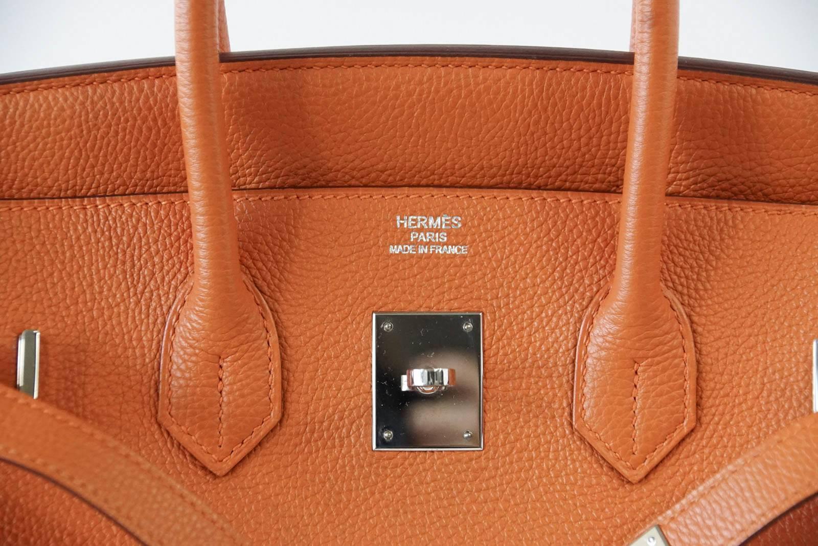 Guaranteed authentic Hermes Birkin 35 iconic H Orange is retired and no longer produced.
Fresh with palladium hardware.
Togo leather is textured and scratch resistant. 
Just returned from Hermes Spa!
Body and interior are spotless.  Barely any