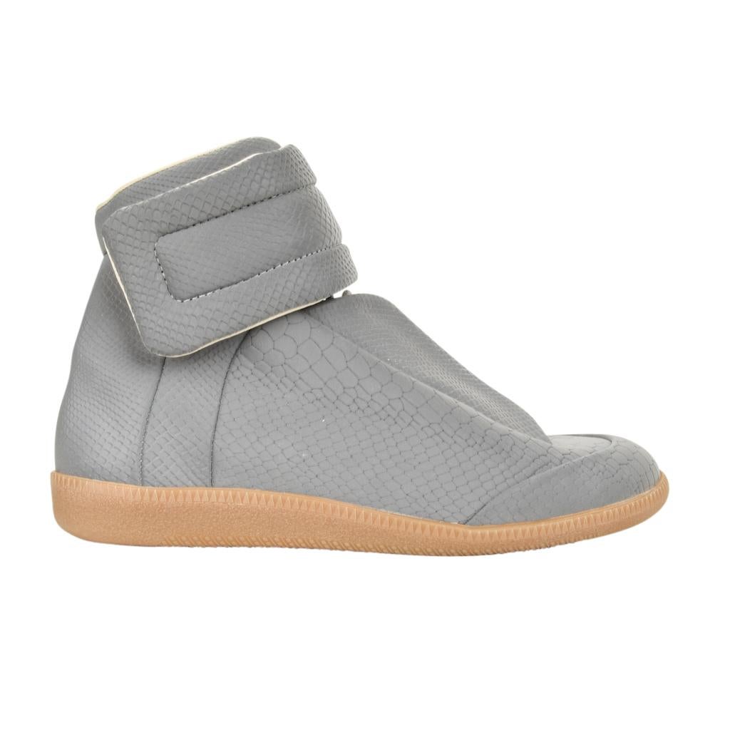 Guaranteed authentic rare MAISON MARTIN MARGIELA men's Irridescent grey reflective high top sneaker.  
Lace up front with lace guards on the sides.
The shoe is snake printed polyester fabric with a remarkably subtle sheen.
Velcro closure grip straps