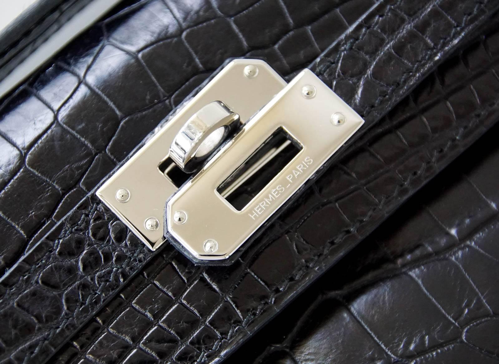 Guaranteed authentic HERMES sleek Black Matte Crocodile Kelly Pochette.
Fresh with Palladium hardware.
Signature stamp on interior.
Small interior compartment.
Clean corners and barely any markings on hardware.  
Extremely light natural wear marks