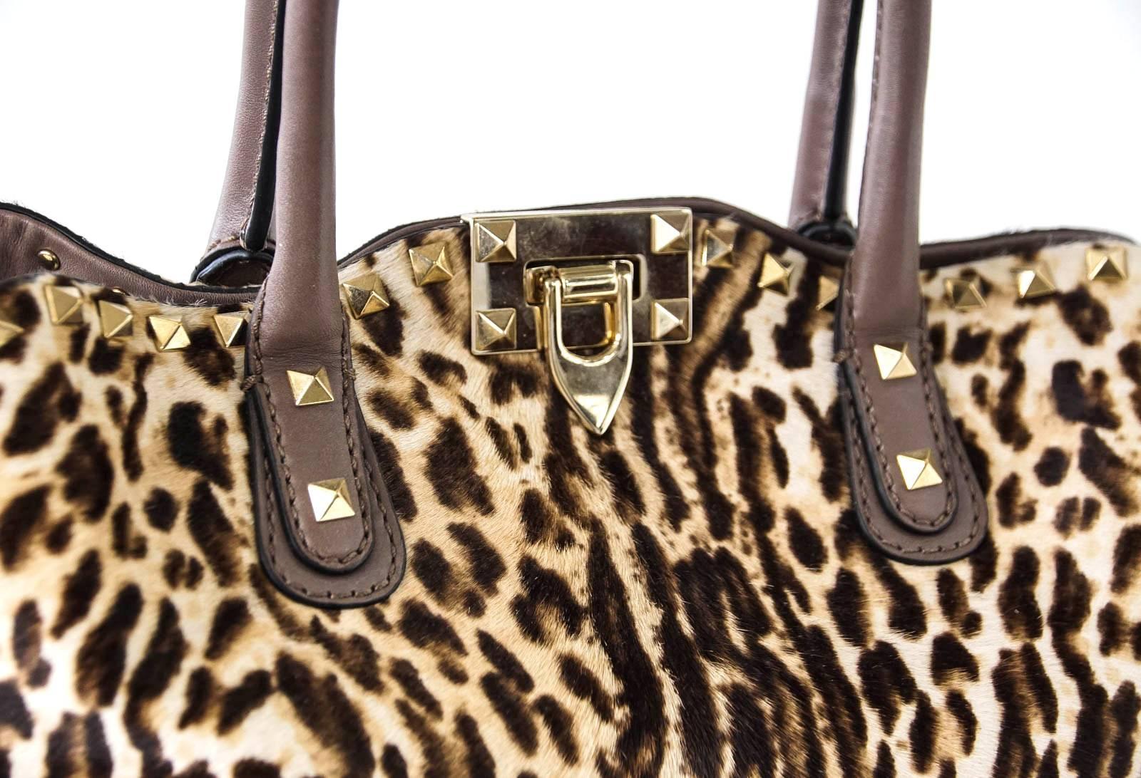 Guaranteed authentic VALENTINO GARAVANI Calf Hair Cavallino Animal Rockstud Dome Satchel tote bag.
Calf hair in animal print. 
Light brass signature studs and closure clasp.
Detachable leather shoulder strap with rockstuds. 
Leather handles and base
