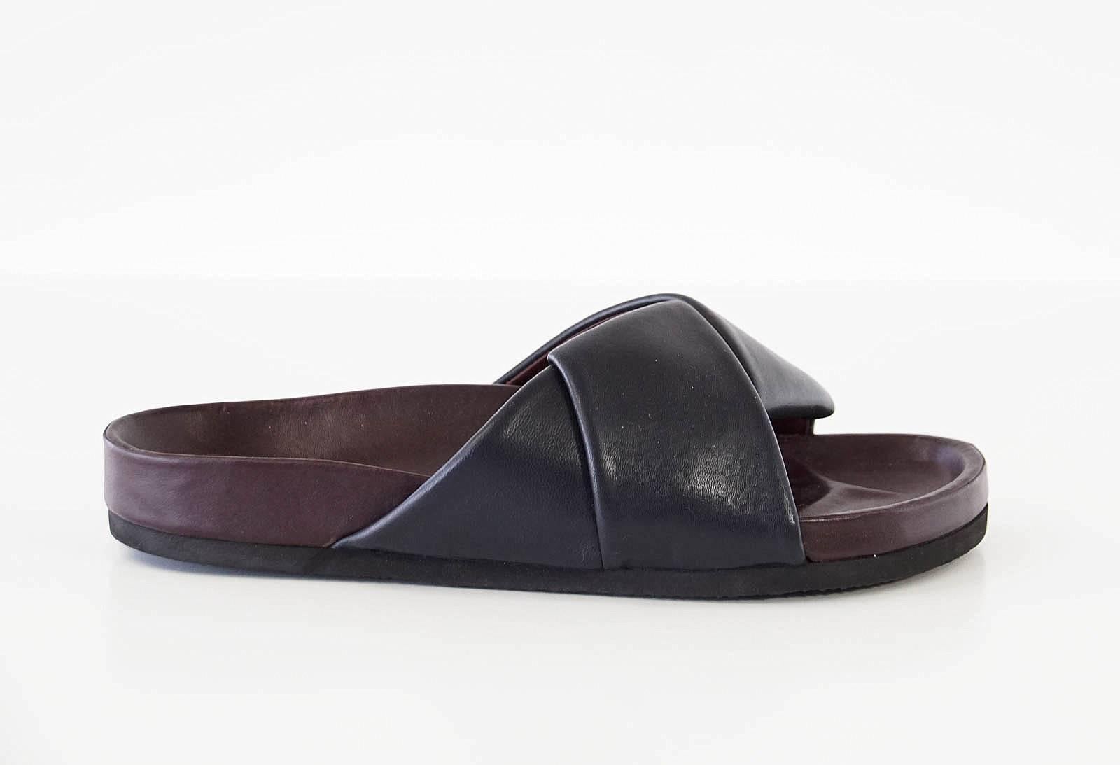 Guaranteed authentic CELINE navy slide sandal with modifed men's wear styling.  The summer IT sandal!
Buttery soft navy blue leather set atop cordovan shaped 'birkenstock'
SO comfortable!
**Runs big - fits 9**.

SIZE 38 
USA SIZE 8

SHOE
