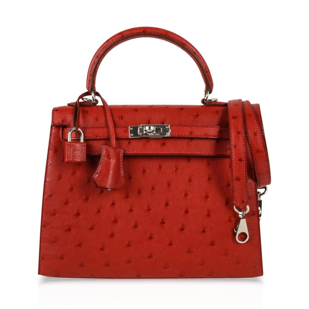 Guaranteed authentic rare and coveted Hermes Kelly 25 Sellier.
Timeless Ostrich in vivid Rouge Vif with signature pink topstitch!
Fresh with Palladium hardware. 
Comes with signature HERMES box, raincoat, shoulder strap, sleepers, lock, keys and
