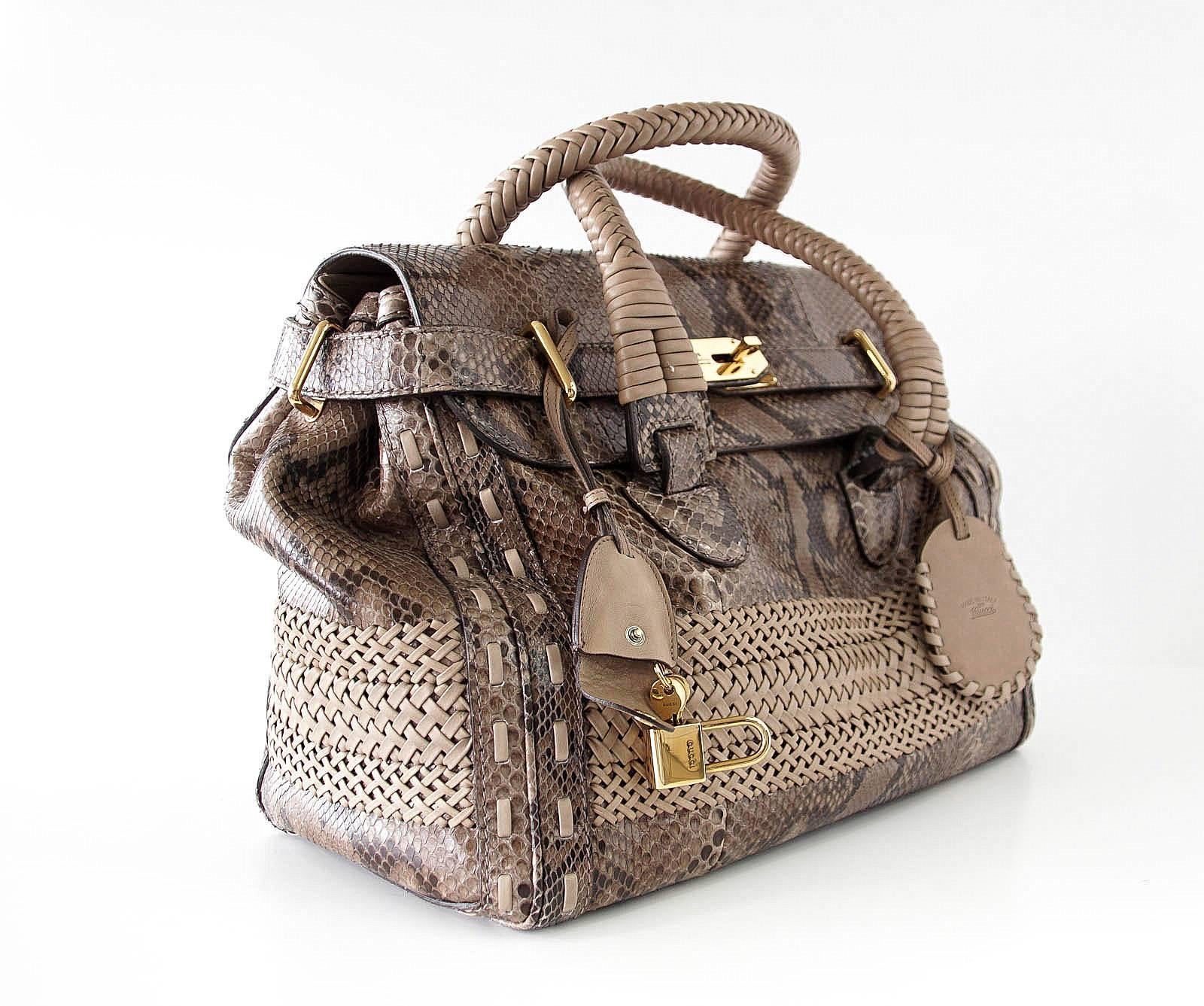 Guaranteed authentic GUCCI taupe snakeskin bag.
Taupe snakeskin bag with woven leather detail.
Woven leather handles.
Top flap closure with 2 straps around front.
Embossed gold hardware and lock.
Handles have clochette with keys and luggage
