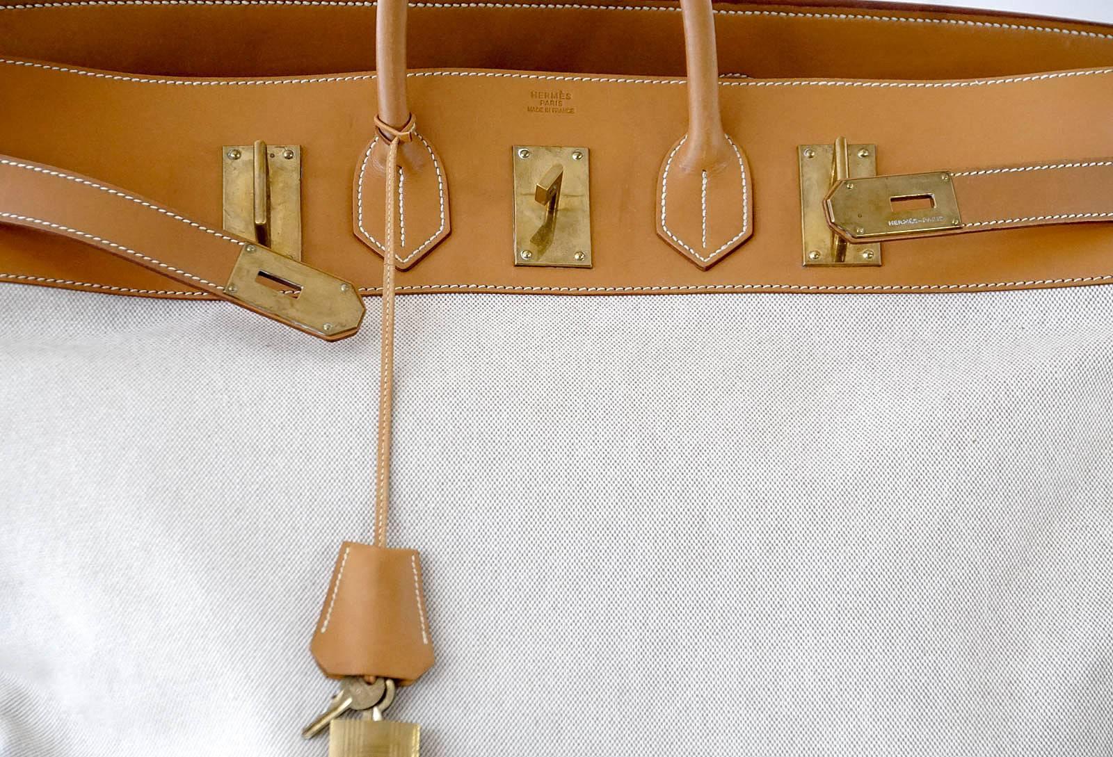 Guaranteed authentic Rare Vintage 55 Hermes Hac in Toile and Vache Naturelle leather. 
Beautiful combination with brass hardware.  
This beautiful travel bag is a true Hermes collectors treasure as the size is now retired.
Minor natural wear