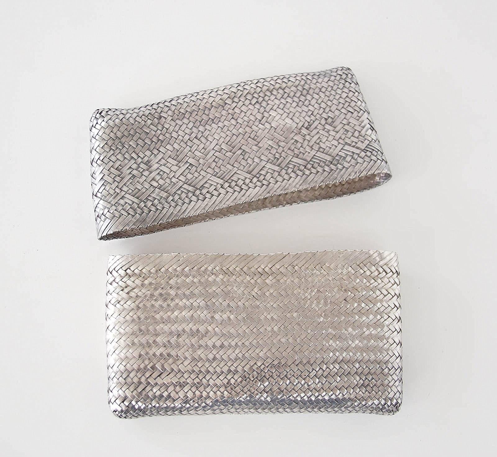 Guaranteed authentic TIFFANY&Co charming vintage ELSA PERETTI  woven sterling silver clutch bag.
The cap top of the clutch slips off to reveal interior and the sterling logo plaque.
The clutch has developed a patina which can be polished off or left