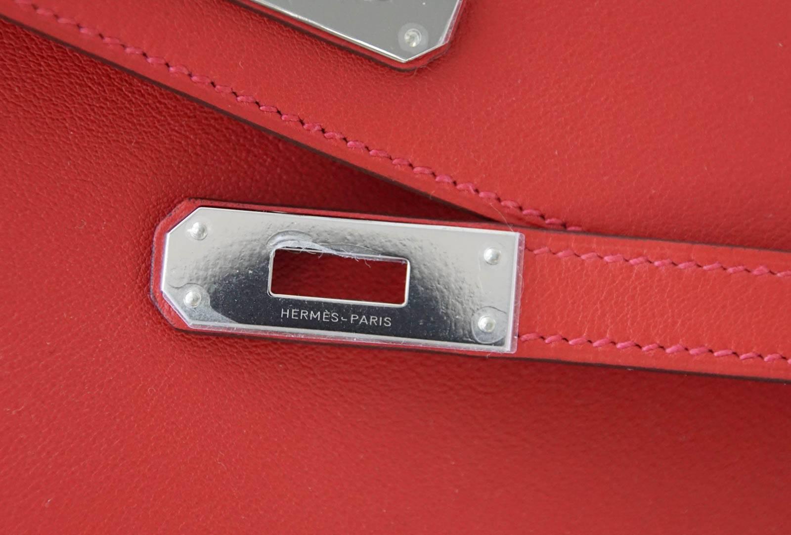 Guaranteed authentic timeless Hermes Kelly Cut  clutch bag featured in rich warm Vermillion red.
Swift leather.
Fresh with palladium hardware. 
Comes with sleeper, signature Hermes box and ribbon.    
NEW or  NEVER WORN. 
final sale

BAG