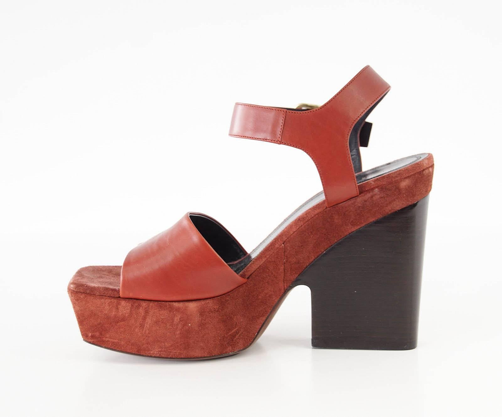  
Guaranteed authentic Celine leather and suede platform shoe. 
Open toe platform shoe in a rich rust with bold straps.
Platform is suede with leather straps.
Shaped wood stacked block heel.
Shoe has a light mark on strap across toes. 
NEW or NEVER