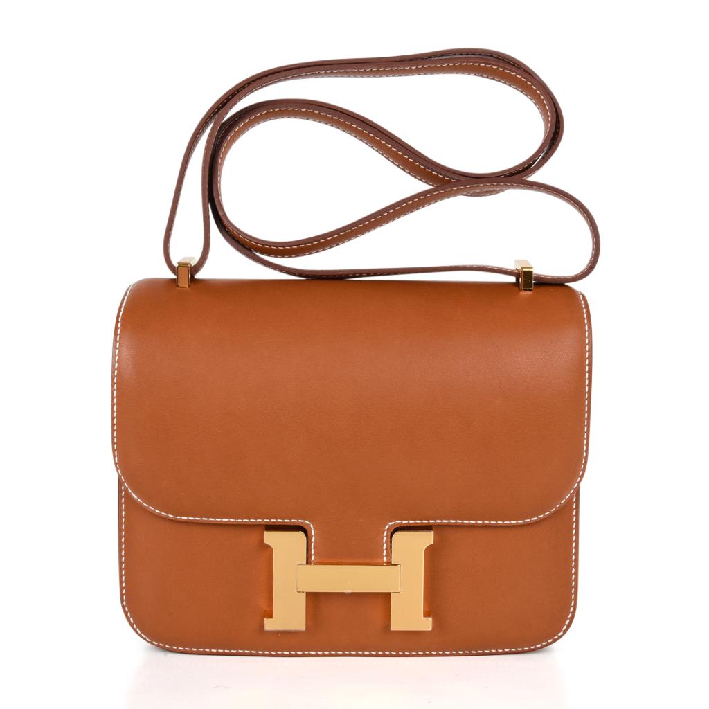 Guaranteed authentic Hermes 18 Constance featured in coveted and rare Barenia leather. 
Accentuated with gold hardware and bone top stitch.
HERMES PARIS MADE IN FRANCE is stamped on front under flap. 
Comes with signature Hermes orange box and