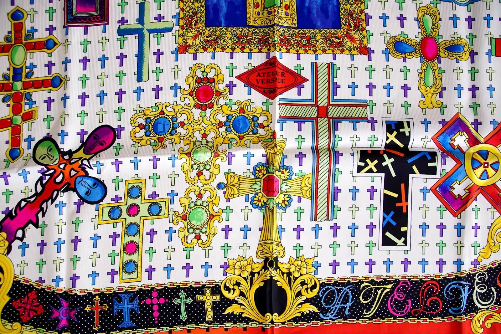 Guaranteed authentic GIANNI VERSACE ATELIER Vintage scarf with stunning colors and hand rolled edge.
Beautiful Vintage silk scarf depicting multiple detailed crosses in colors of gold, yellow, red, purple, blue, green, and white.
Exquisitely drawn