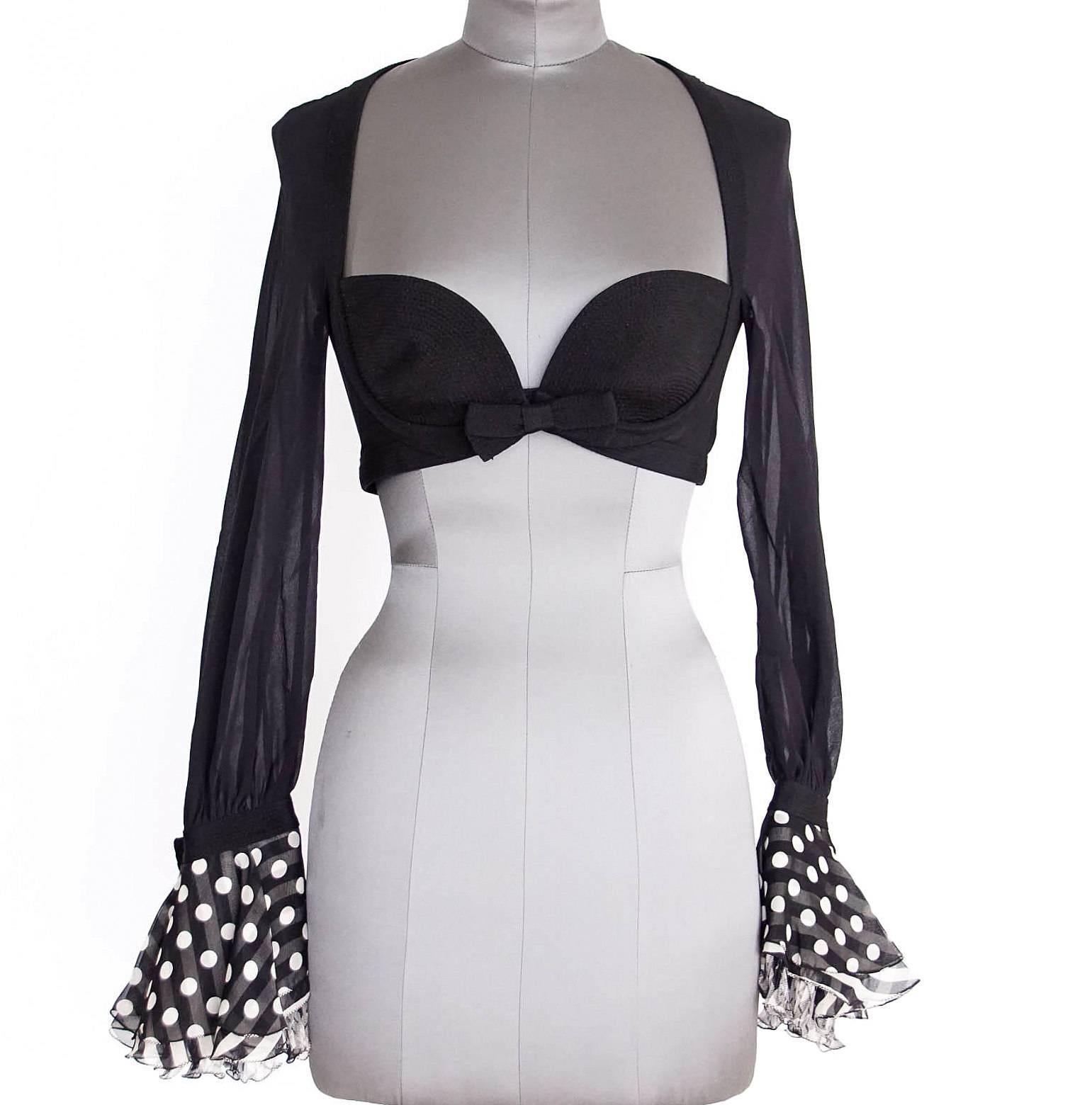 Guaranteed authentic GIANNI VERSACE COUTURE Vintage black semi sheer silk bra top
with built in bra cups.
Front hook and eye closure under decorative bow.
Beautiful sheer long sleeves with ruffled cuffs in tiered polka dot, stripe, and argyle