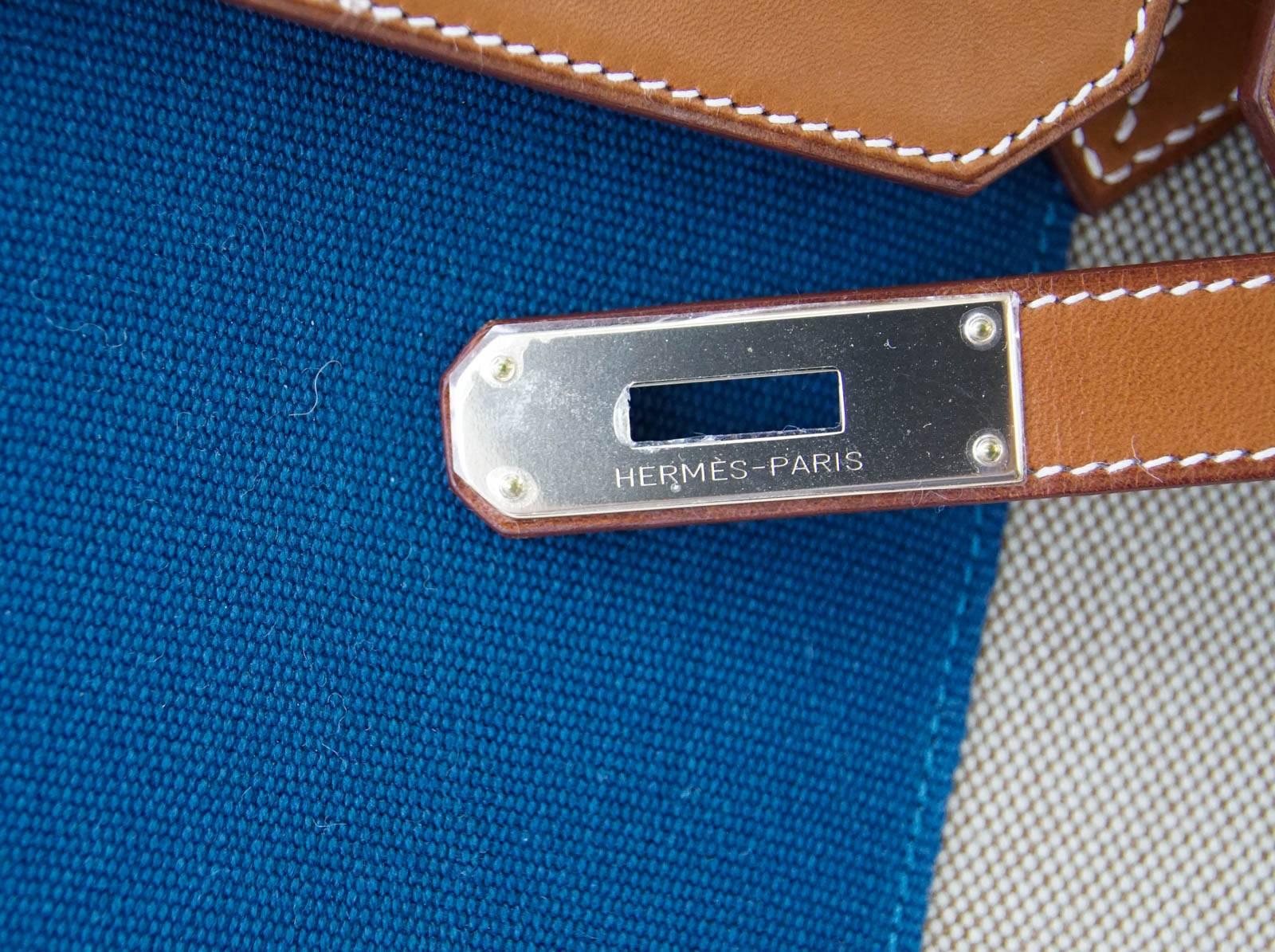 Guaranteed authentic Limited Edition no longer produced Hermes Birkin 35 Flag bag.
Coveted Barenia leather combined with Toile with chic Blue accent.
Permabrass Hardware.
Comes with signature Hermes orange box, sleepers, lock, keys, and