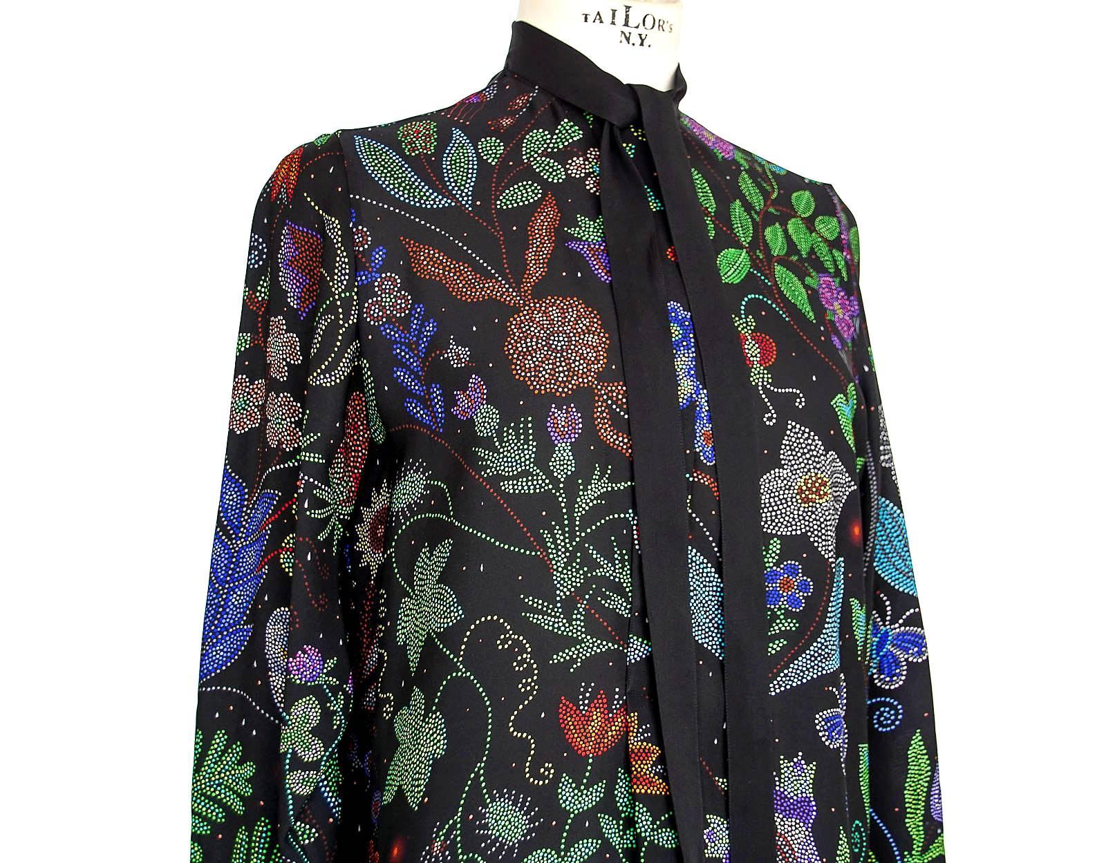 Guaranteed authentic Valentino floral print silk tunic in a rich profusion of colours.
Created by very small polka dots and accentuated with pretty butterflies.
Black self tie and 3 black buttons in front.
1 Button on each cuff.
Fabric is 100%