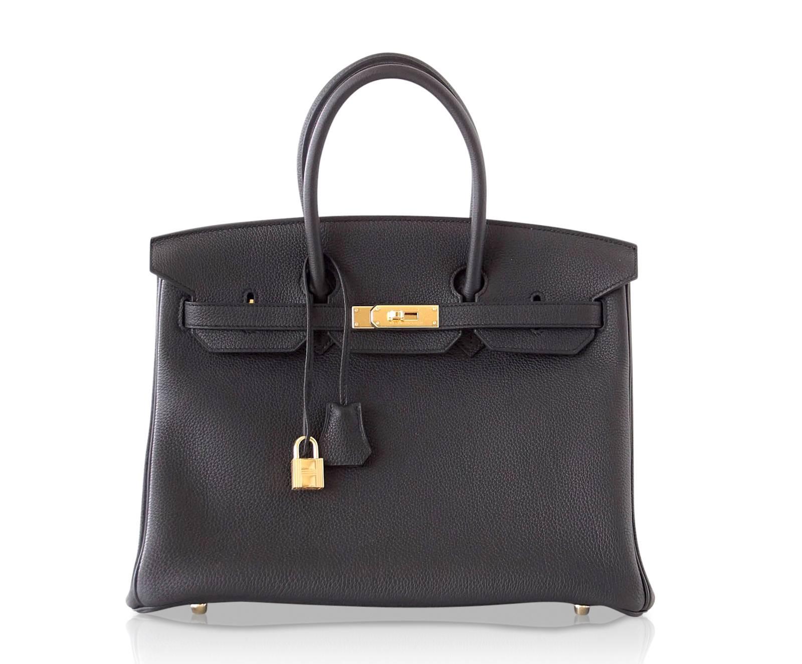 Guaranteed authentic sleek classic Black Hermes Birkin 35 is timeless.
Togo leather is textured and resistant to scratches.
Coveted with gold hardware.
Comes with lock, keys, clochette, sleepers, raincoat and signature Hermes orange box.
NEW or