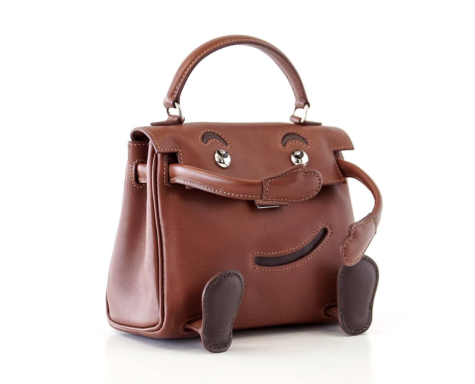 Guaranteed authentic whimsical Hermes Limited Edition Noisette Quelle Idole Kelly Doll in Gulliver leather.
This charming little bag with appliquéd features and movable appendages was crafted as part of Hermes' millennium celebration.
Classic Kelly