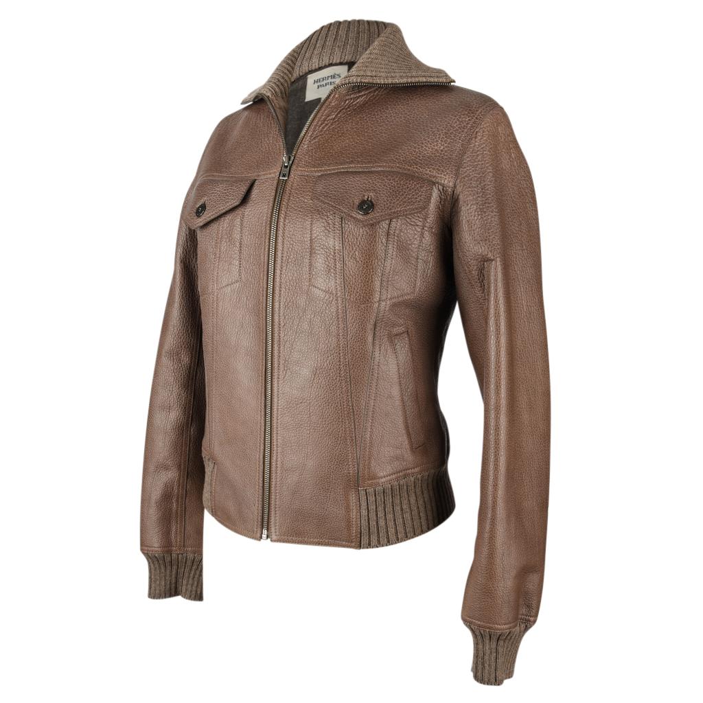 Guaranteed authentic Hermes chic bison leather jacket.
Bomber jacket in taupe with a gray wool flannel lining.
Knit ribbing around hem, cuffs and neck.
Front zip with logo embossed pull.
2 breast pockets with logo embossed buttons and 2 slot
