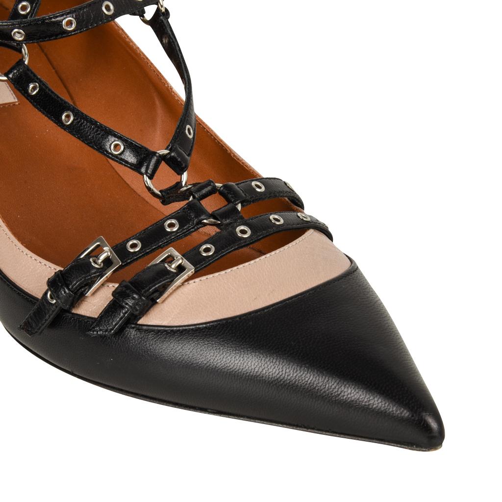 Guaranteed authentic Valentino Garavani strappy ankle strap pump with fabulous details. 
Black and camel pump with grommet studded straps. 
Small adjustable buckles.
Straps cross over foot and around ankle.
Pointed toe with low shaped heels.
final