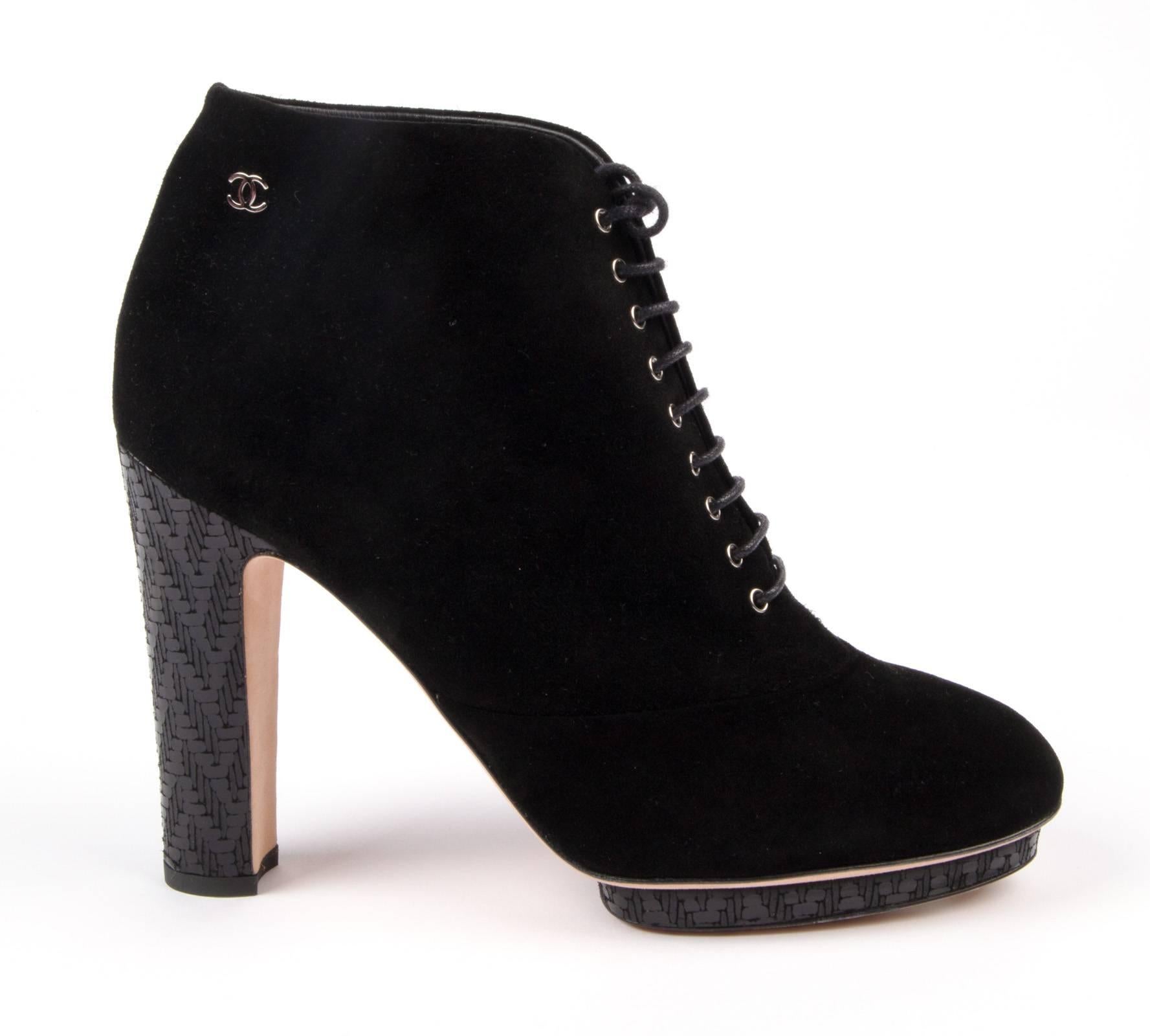 Guaranteed authentic fabulous Chanel jet black heavenly soft suede ankle boot  bootie with Deco patterned blue heel and small platform.
Very sophisticated colour combination accentuates the rich suede. 
Small CC silver logo on the side. 
Comes with