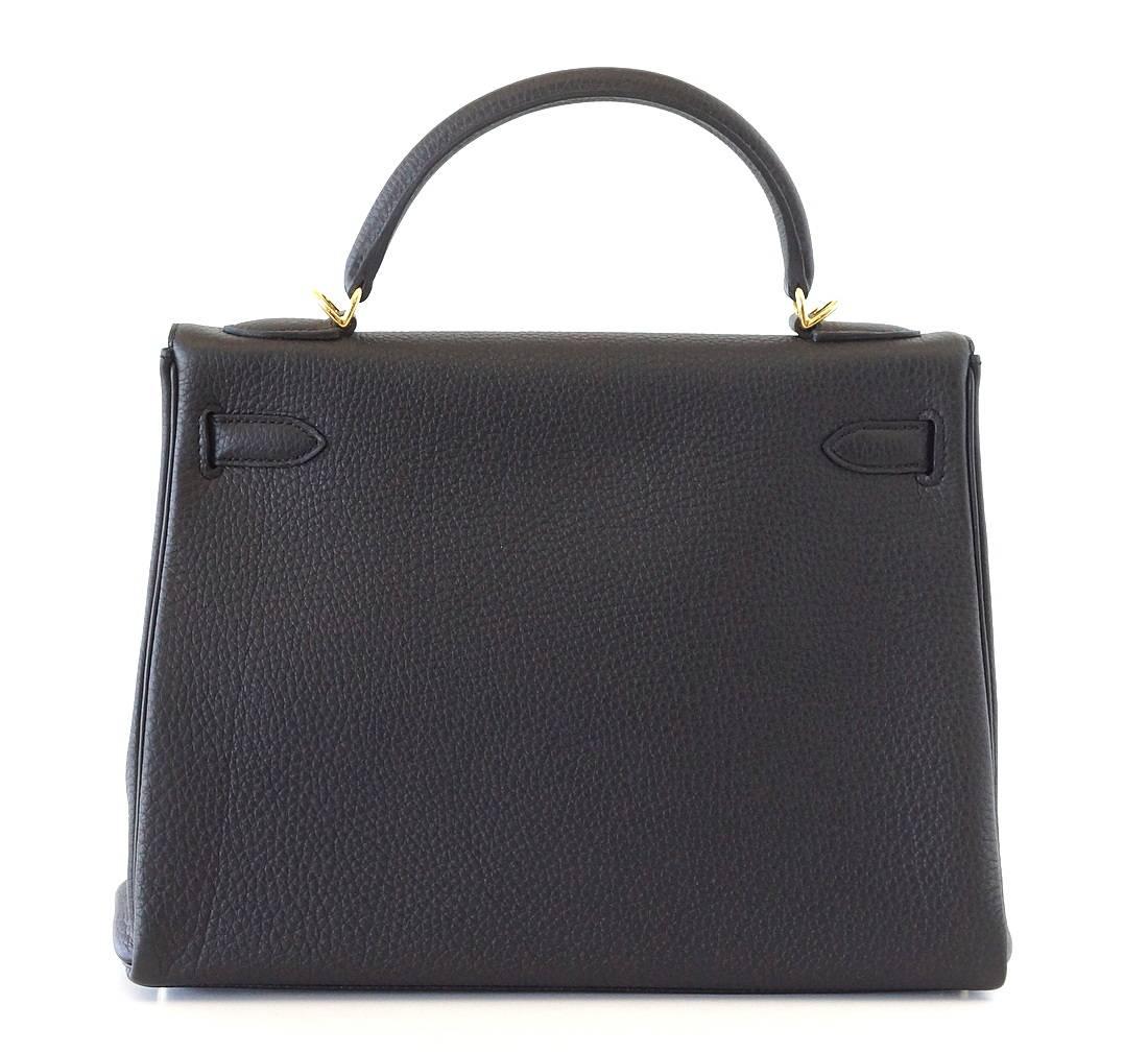 Coveted jet black with rare gold hardware.
A chic and timeless treasure.
NEW or NEVER WORN.
Comes with signature HERMES box, raincoat, shoulder strap, sleepers, lock, keys and clochette.
final sale

BAG MEASURES:
LENGTH  32cm / 12.5"
TALL  23cm