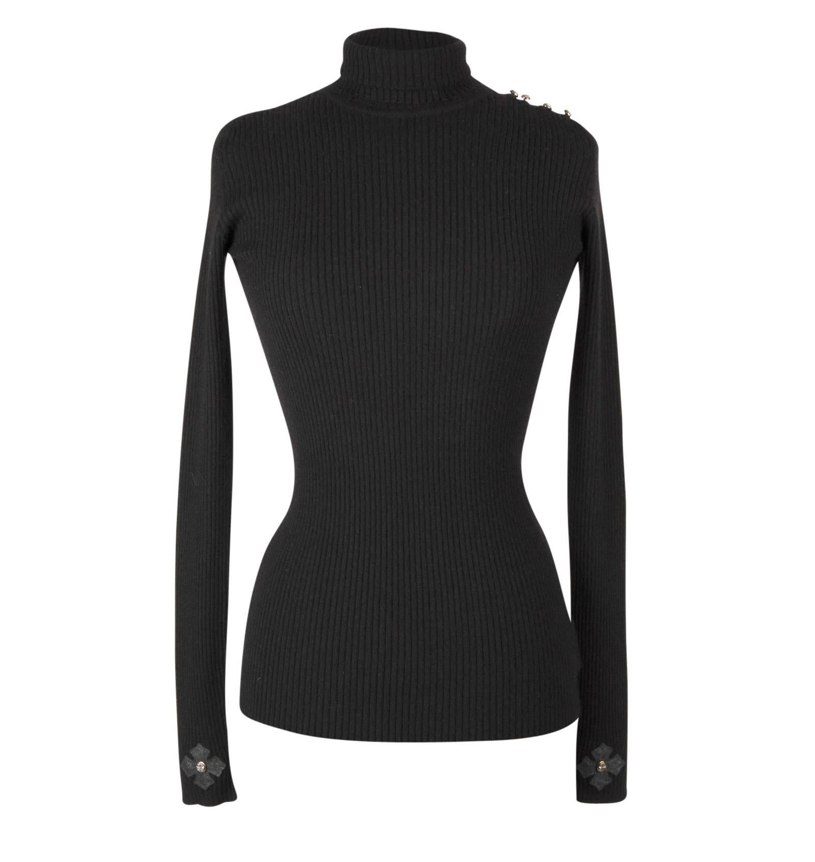 Guaranteed authentic Chrome Hearts Black very soft and light Cashmere turtleneck.   
Signature leather cross and sterling silver filigreed stud at cuffs. 
One shoulder has 5 sterling silver buttons with leather loops.
Fitted, sleek, timeless.
final