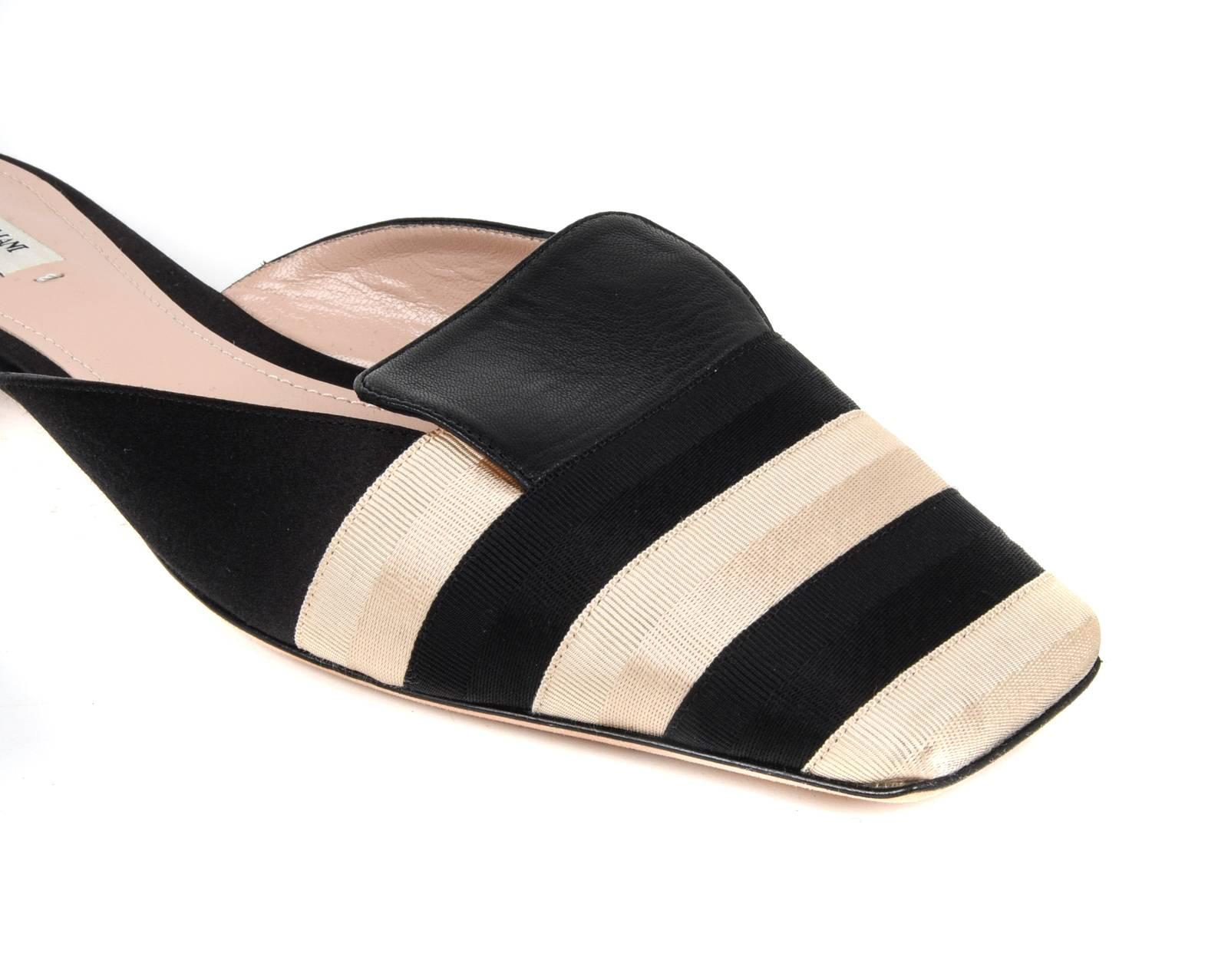 Guaranteed  authentic Giorgio Armani sleek black and gold slide. 
Alternating black and gold grosgrain ribbon with a squared toe.
Beautifully detailed heel created with gold sides and rear black zig zag.
The perfect summer slide.
NEW or NEVER