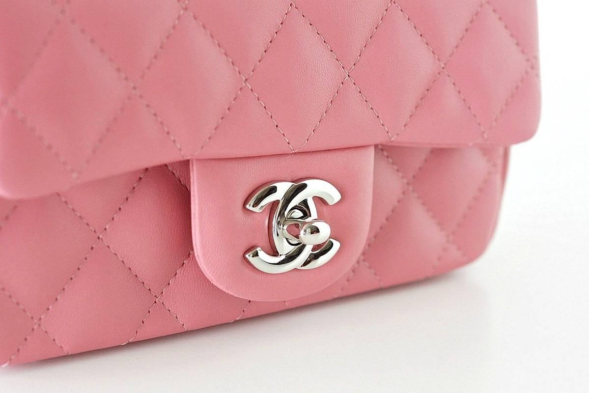 Absolutely fabulous Chanel rectangular mini flap bag rose pink lambskin leather.
Chanel classic, timeless beauty.
Silver CC turnkey and hardware.
Interior has 2 slot compartments and 1 front slot pocket.  
Serial number on interior.  
Signature