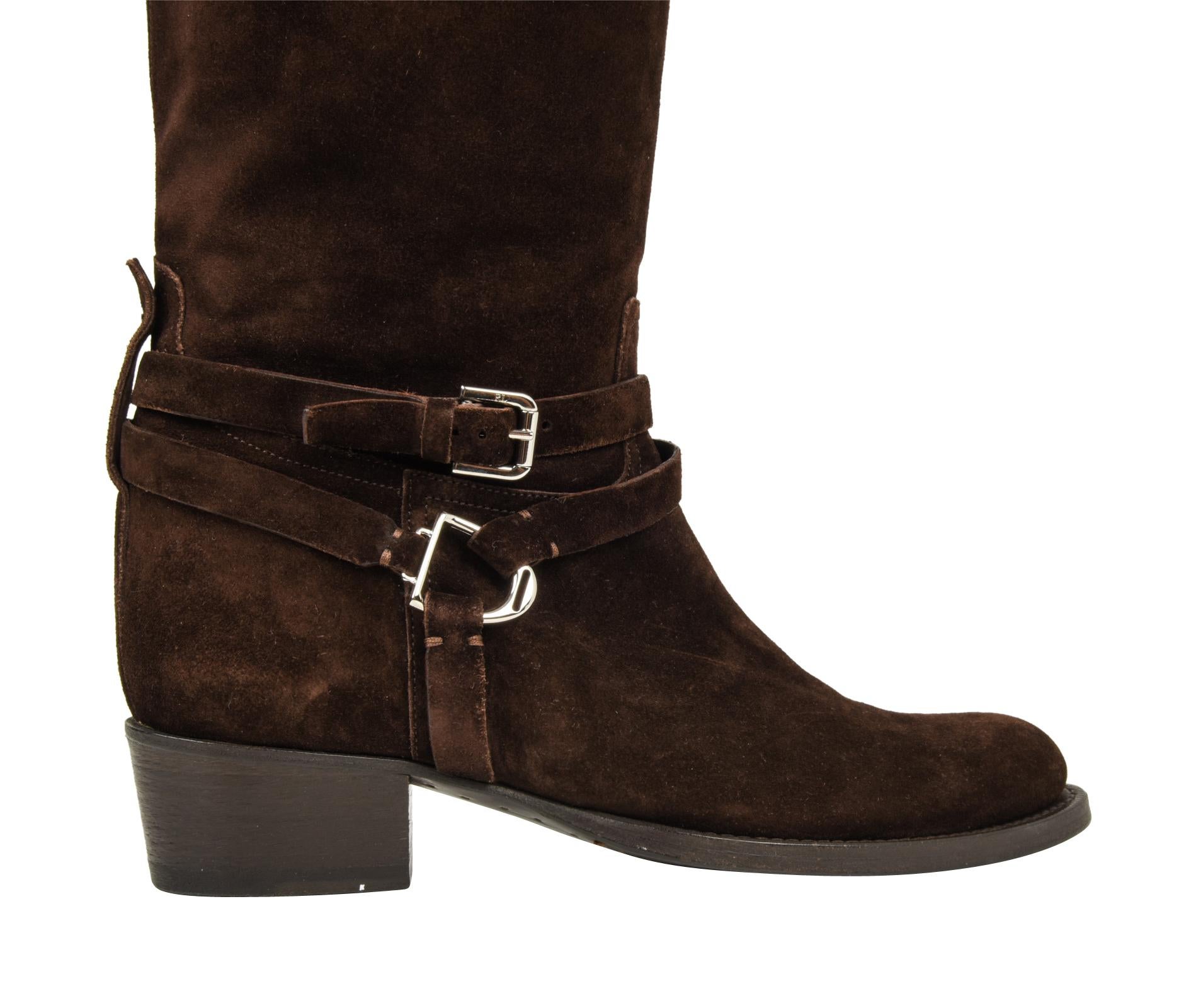 Guaranteed authentic fabulous Ralph Lauren Collection rich brown suede knee high boots.
Ankle has wrap around straps with a silver toned buckle and stirrup.
Rear tab holding straps has a small silver logo embossed stud.
Gently rounded toe and dark