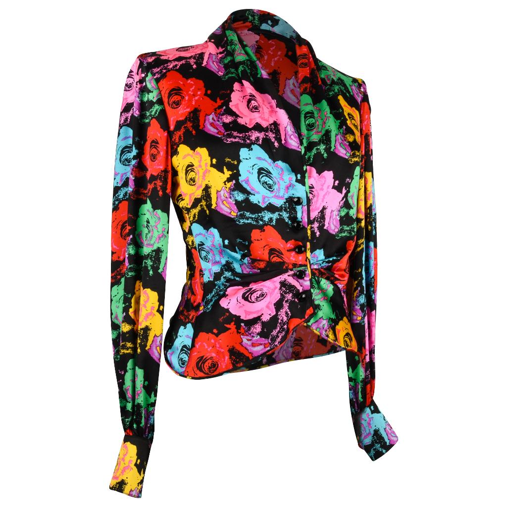 Emanuel Ungaro iconic print vintage blouse. 
Sublime fabulous print of roses in brilliant reds, pink, blue, yellow and green on a black background. 
Accented with jet black crystal buttons on cuffs and in front. 
The waist has gentle draping that