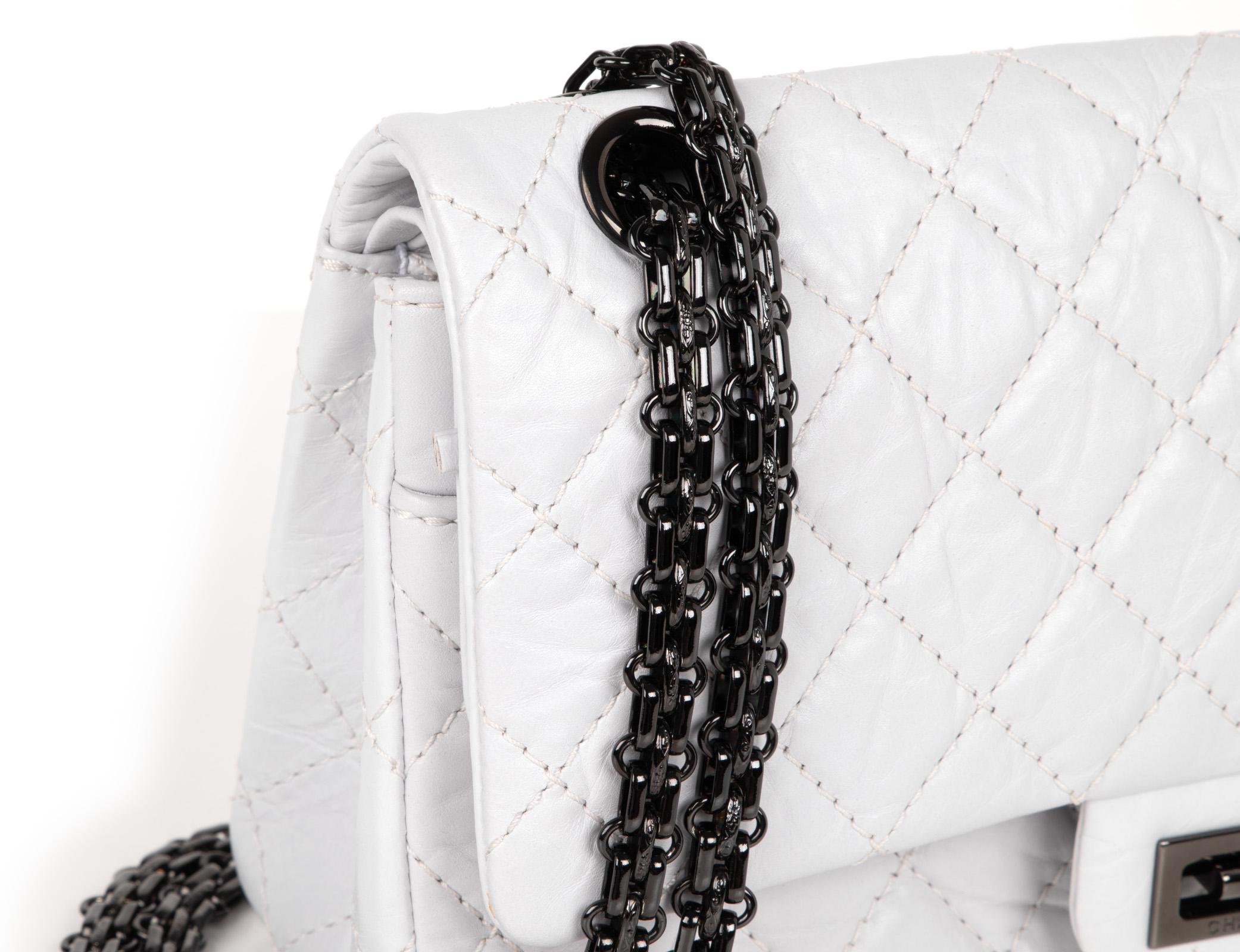 Chanel Small 2.55 double flap bag in unique chalk white distressed calfskin leather.  
Hematite logo embossed Mademoiselle turnkey and link chain strap which can be doubled.
Rear exterior slot pocket.
Signature CHANEL stamp inside the bag. 
Comes