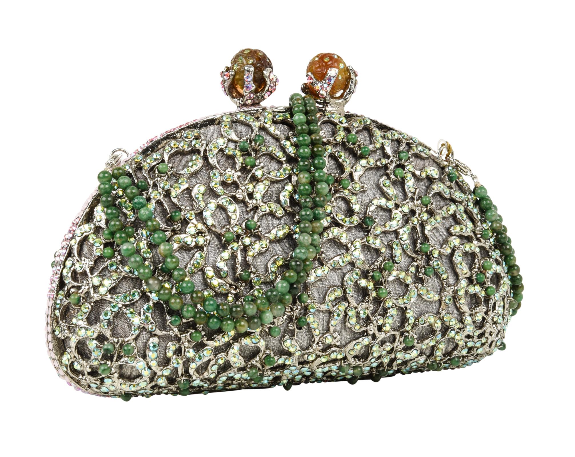 Exquisite hand-made evening purse encrusted with approximately 2000 crystals evening bag.
Jade beading set on wiring.
Beaded jade double strand handle is removable adding versatility to this clutch / handbag.
Lined in finely textured pewter