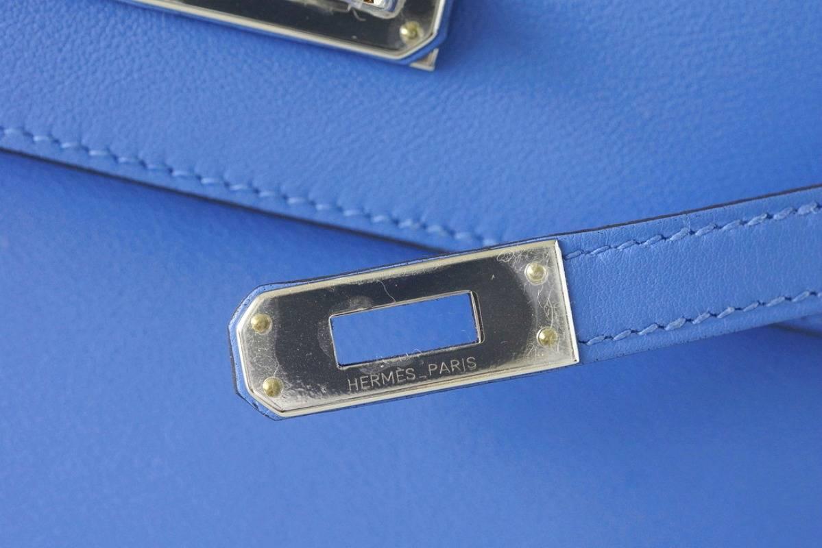 Guaranteed authentic Hermes Kelly Pochette clutch bag Blue Paradis is an exquisite year round color.
Fresh with Palladium hardware.
This treasure can be carried day or night. 
Stamped HERMES MADE IN PARIS on the interior.
Small interior