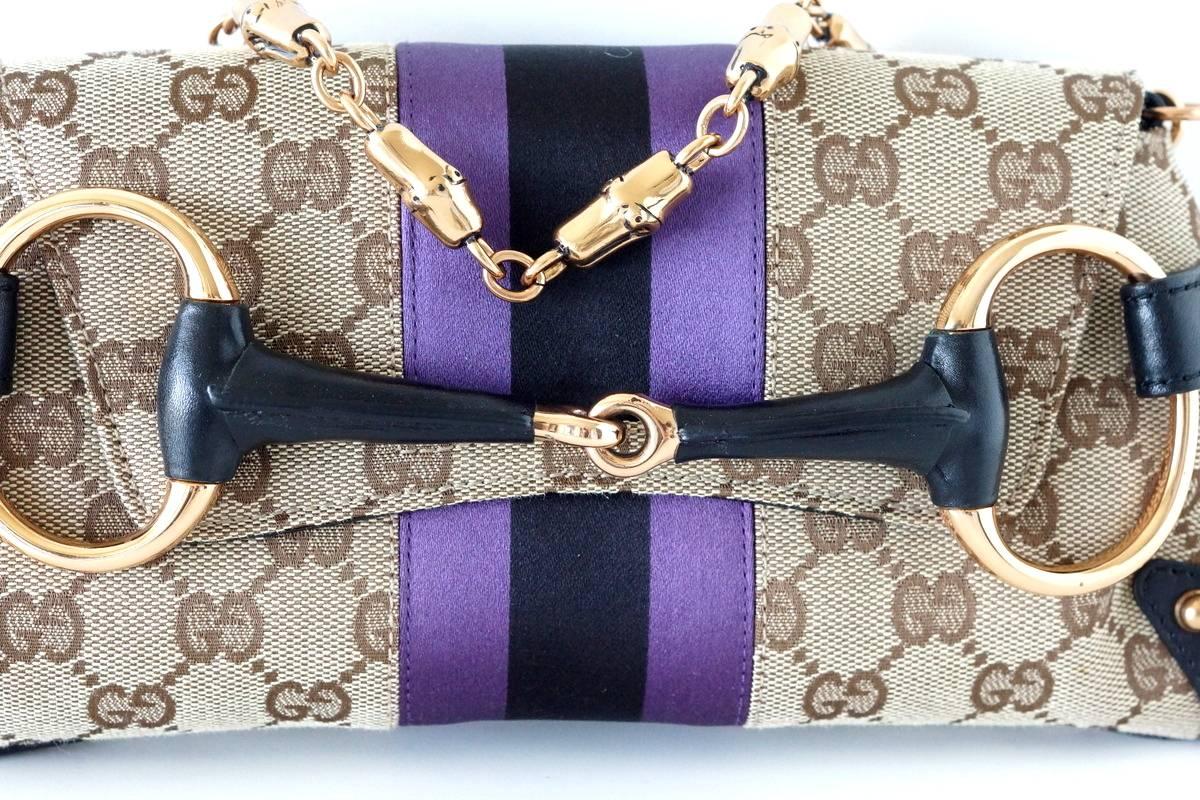 Iconic brown Gucci GG monogram Tom Ford created in his final season with Gucci.  
Detachable richly crafted heavy bamboo rose gold chain.
Bag can be carried as a clutch or shoulder.
Black and purple satin center stripe.
Horse bit front in rose gold