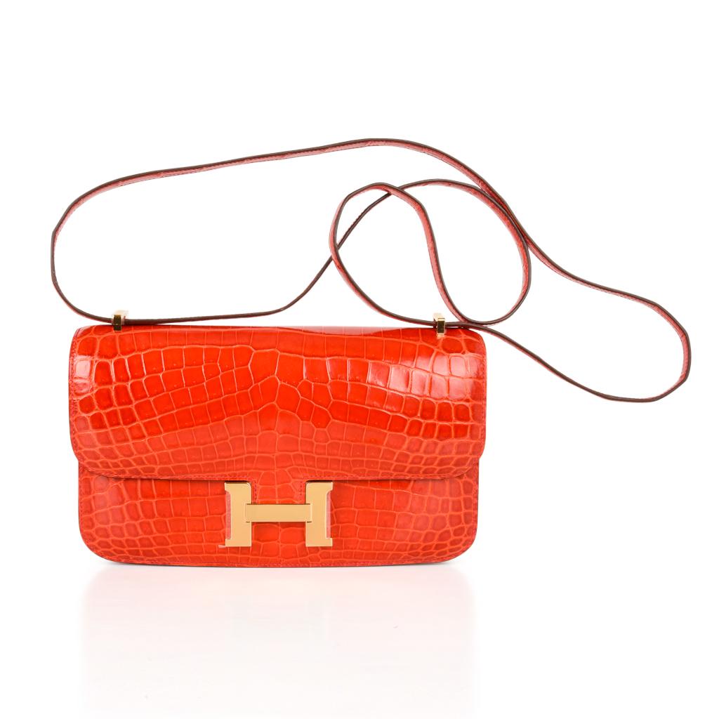 Coveted Hermes Constance Elan crocodile in vivid Geranium with gold hardware could not be more exquisite. 
Understated sophistication has made this one of the most desired bags.
Carried by hand, over the shoulder, or even across the body.
HERMES