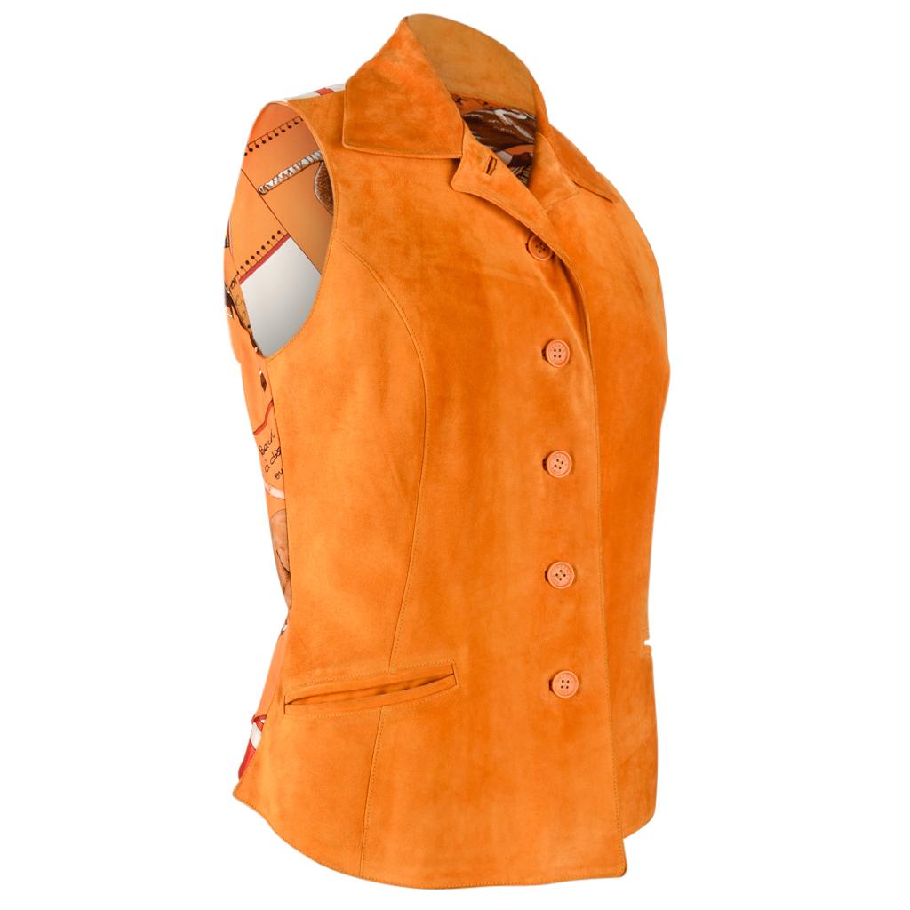 Guaranteed authentic Hermes vintage vest features lush burnt orange suede front with rear scarf print silk Hermes Cup Palm Beach Polo.
Intracite detail to the riders and horses colours are orange, browns, white, greens, blues and reds.
Rear elastic