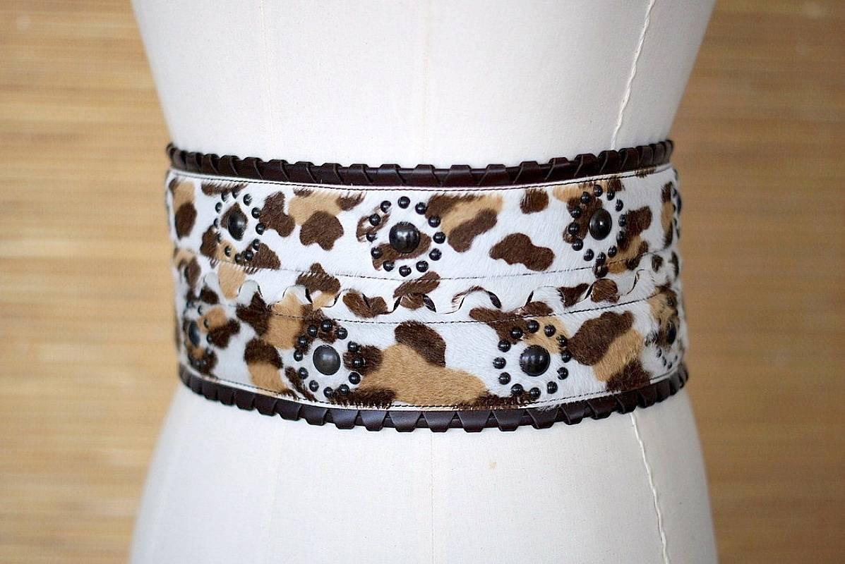 Azzedine Alaia vintage corset calf fur leopard print belt in shades of brown on the white background. 
Edged in chocolate brown leather that 'loops' with leather running through. 
Center of belt is undulated with a hidden 'rod' that holds it