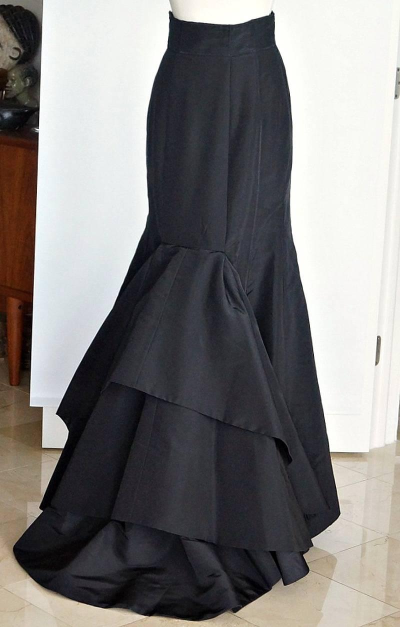 Guaranteed authentic OSCAR de la RENTA exquisite formal black silk taffeta floor length skirt.  
Superb cut from the front that is accentuated with the exquisite large ruffled rear.
Sublime fit.
This piece works from Sharon Stones' white shirt to