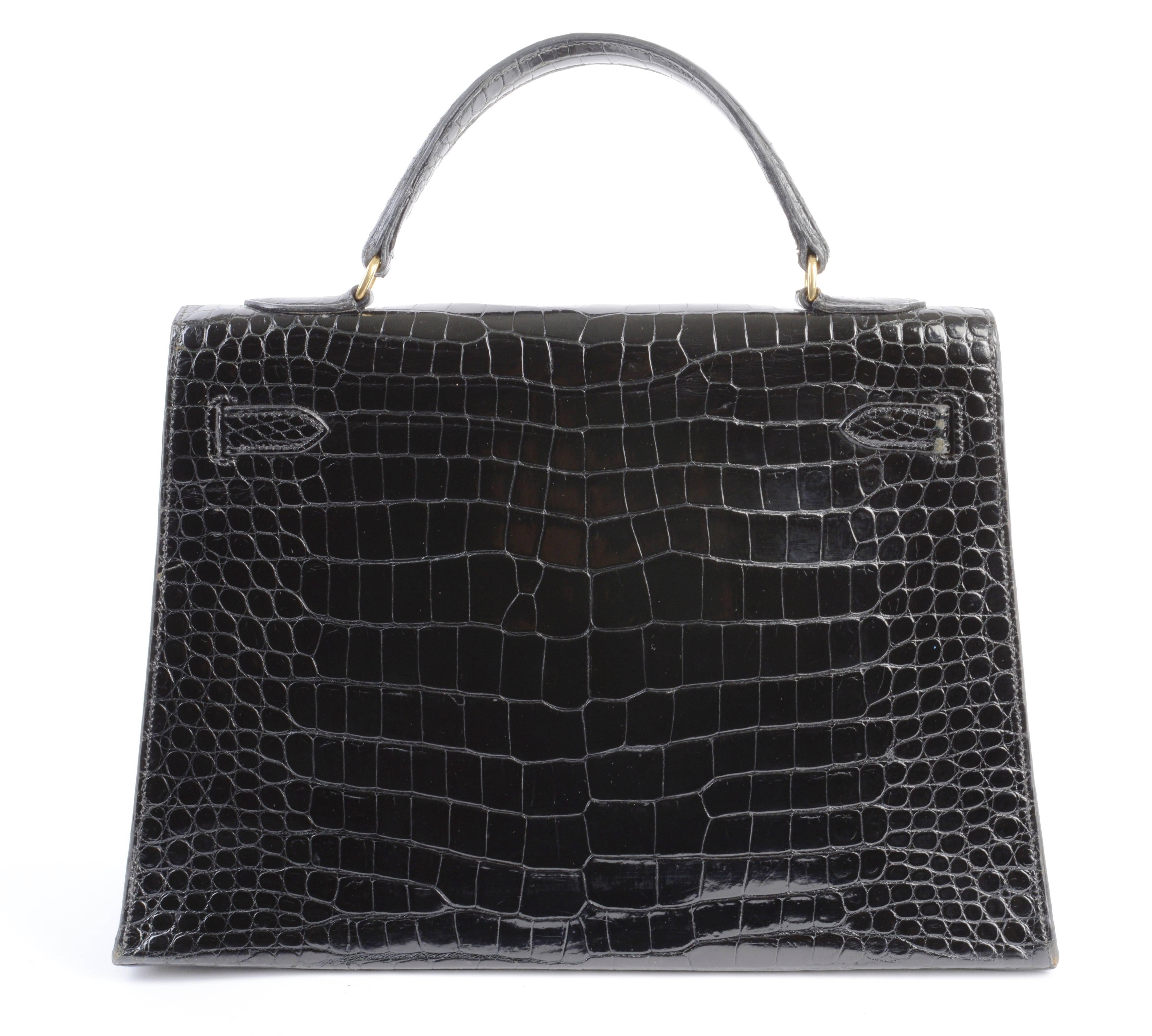 Hermes 32cm Shiny Black Crocodile Sellier Kelly Bag with Gold Hardware
Circa 1950's. This Kelly bag is classic, refined, and elegant. The bag has been a staple luxury accessory since its introduction in the 1930s. This particular Kelly is stunning.