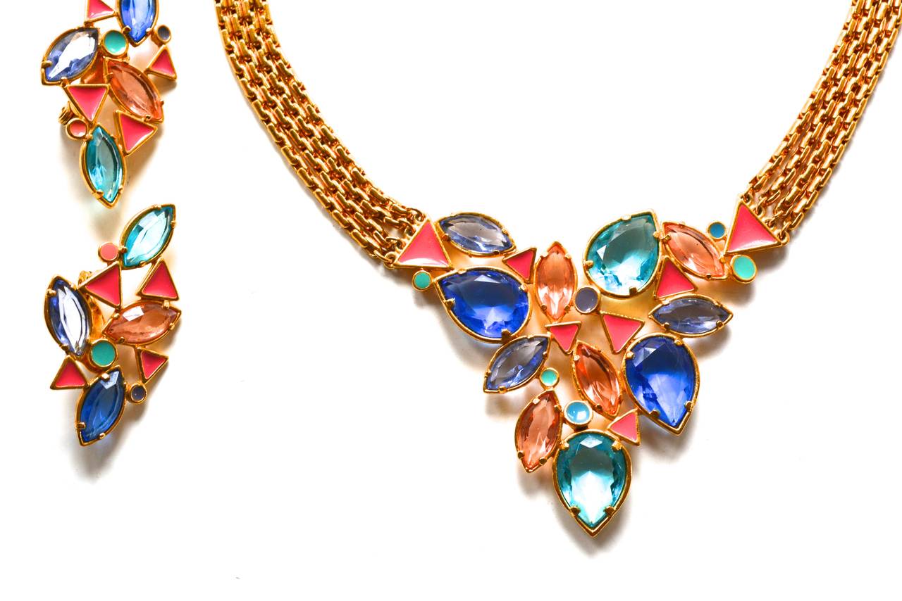 Pretty pastel and golden metal parure with glass stones and enamel details. The colors are spectacular. Signed YSL. Circa early 1980s.  Quality construction and design. The earrings have great scale and are pierced with a clip closure. The necklace