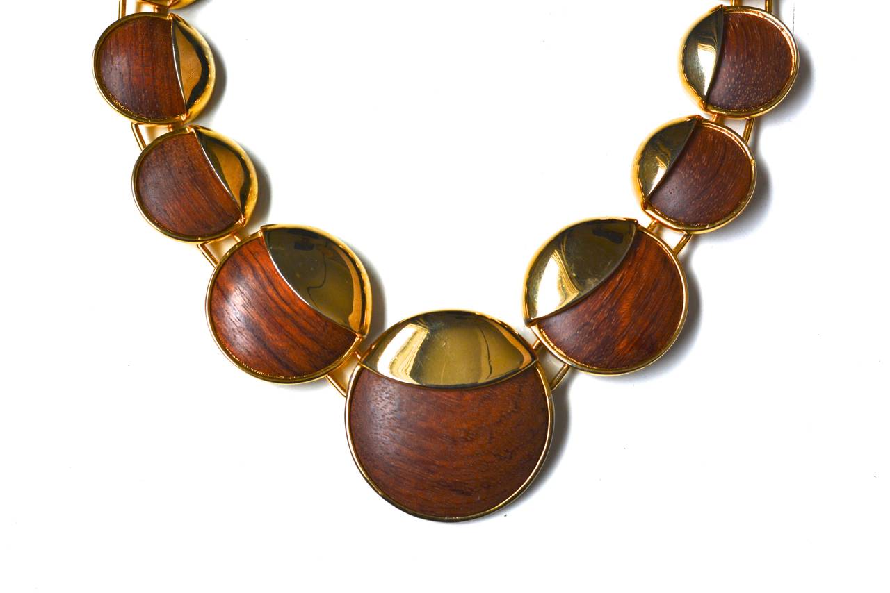 Amazing mix materials signed Alexis Kirk designer necklace. Simple hook clasp and rich wooden disc design. The scale is great, yet the piece is very wearable. Circa 1970s-early 80s. The largest center disc measures 2