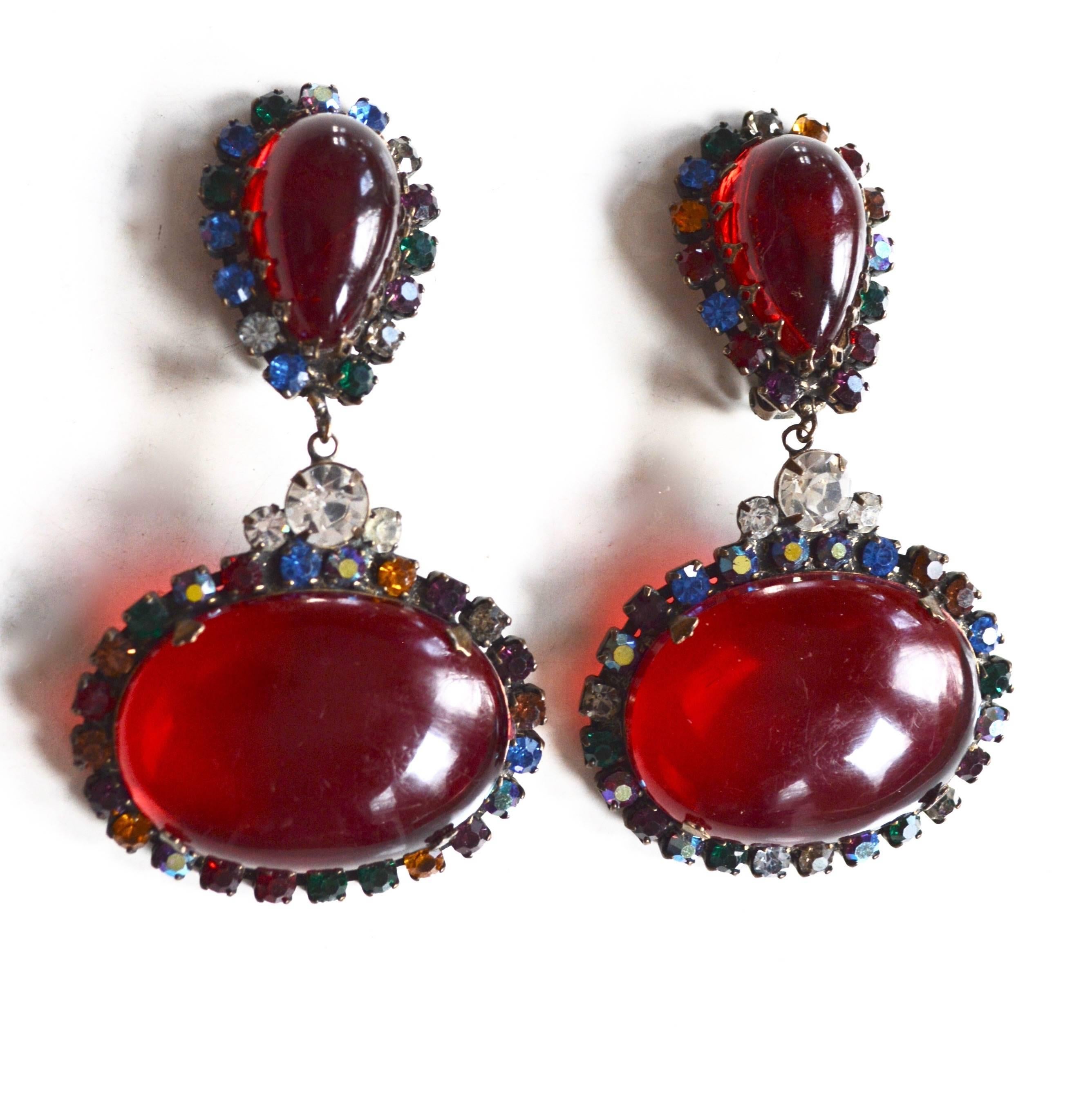Rare cherry red large rhinestone and red cabochon earrings. Signed by Kenneth Jay Lane in the early signature style. These almost have the feel of bakelite, but I did not test them. Great look! Mild overall surface wear, bronze finish. Reside from a